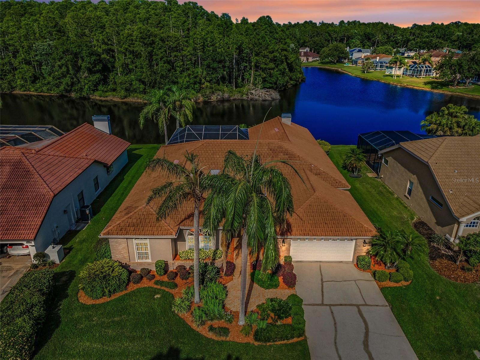Beautiful Custom Lakefront Home in the popular East Lake Corridor. NEW $40,000 tile roof 2020. TWO NEW Trane high-efficiency HVAC systems 2023. Pool was RESURFACED with a Pebble Tec finish, NEW pavers, and NEW mechanical equipment 2023.
Located in a desirable NO FLOOD ZONE neighborhood, this move-in-ready home offers 3 bedrooms, one with Murphy bed that can be used as an office, 3 bathrooms, and 3164 sq ft of thoughtfully upgraded living space. Ideally situated, just minutes from top-rated beaches, parks, shopping, and dining, the home combines convenience, luxury, and peace of mind.
Step inside to a grand 12-foot ceiling foyer with custom glass double doors and sidelights. The formal living and dining areas feature tiered ceilings and decorative architectural details, while the spacious family room includes a gas fireplace and built-in cabinetry.
The updated kitchen boasts solid maple cabinets, stainless steel appliances, under and over-cabinet lighting, a pantry, and a breakfast nook with a 3-panel aquarium glass window overlooking the lake and pool.
The oversized primary suite offers a large walk-in closet and a FULLY REMODELED en-suite bathroom with a soaking tub, a walk-in shower, and dual vanities. Two additional full bathrooms have also been REMODELED.
Additional features include: Porcelain tile flooring throughout the main living areas and two bedrooms. Large laundry room with washer/dryer, utility sink, and upper storage cabinets. Covered lanai with pool, spa, and tiki bar featuring a sink, refrigerator, and Key West-style metal roof. Multiple storage closets throughout the home. Crown molding, glass block accents and more.
Enjoy peaceful lake views and direct sightlines to a conservation area, where you can watch the sunrise and local wildlife from your private backyard oasis.
This home offers luxury, functionality, and a prime location-perfect for Florida living.