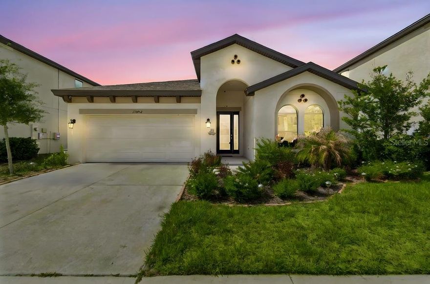 Experience refined living in this exceptional CUSTOM HAWKPOINT Mediterranean residence by WESTBAY, where soaring 9.5-foot ceilings and an expansive open floor plan create an atmosphere of elegance and ease. THIS FOUR BEDROOM,TWO BATH, 2089 sqft heated CUSTOM HOME with Beautiful base boards, ceiling fans, and gourmet gas kitchen is a true culinary masterpiece, showcasing Zodiac quartz stone counters, a professional five-burner gas range with designer hood, a dramatic full-height contemporary stone backsplash, and rich maple-slate hardwood cabinetry. The impressive center island—appointed with a culinary sink, seating for five, and premium stainless steel appliances—anchors the space with both beauty and function. A generous walk-in pantry and slate-stone sealed flooring throughout add sophistication and durability.

The living area flows effortlessly through oversized sliders to a beautifully appointed screened sunroom, extending your entertainment space while inviting in natural light. A built-in surround-sound system enriches the ambiance, making this home ideal for both quiet evenings and lively gatherings. Outside, the private vinyl-fenced yard offers a serene outdoor retreat with minimal maintenance. MASTER BATH enjoys dual, his/her seperate sinks and vanities, walk in extra large Roman rain shower beautifully accented and tiled.

Located in a highly sought-after neighborhood served by A-rated elementary, middle, and high schools, this home provides exceptional quality of life without the need for private schooling. Enjoy unmatched convenience with a central location offering just a 45-minute drive to St. Pete, Orlando, and Disney World, with Tampa even closer. Nearby parks, BMX and bike trails, Pickleball courts, play grounds, dog park and effortless access to Route 301 and I-75 complement the lifestyle. Premier shopping, dining, and entertainment from Tampa to St. Pete are all within easy reach.  
FURTHER enjoy the RESORT STYLE amenities from club house a large heated salt water resort lap and lagoon style community pool with splash pad and additional large wading pool.. NO NEED for a private expensive pool here !!!