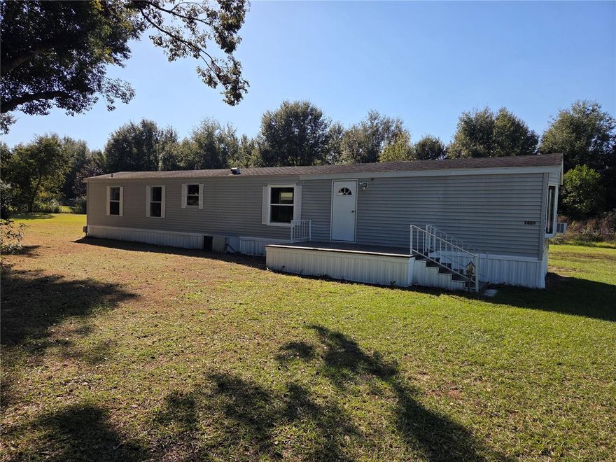2-bedroom, 2-bath manufactured home on 1 Acre in Zephyrhills. The home sits at the end of a private drive with no outlet. 
It has a split bedroom layout, indoor laundry room, new paint, kitchen counter, shower in primary bedroom, large deck, carport and utility shed. 
It is located 1/4 mile from major a grocery store, dining and big box store.
