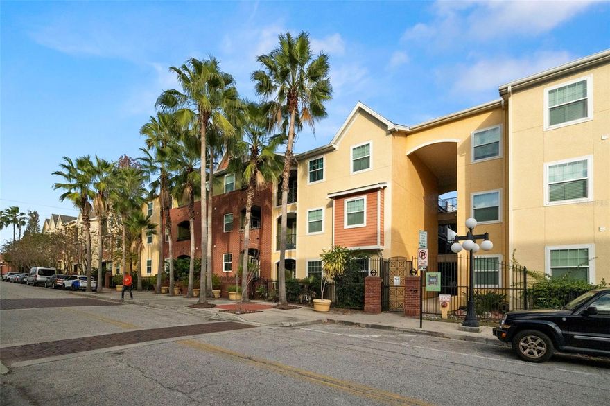 Welcome to The Quarter at Ybor—where historic charm meets modern living! This light, bright, fully renovated first-floor condo has been reimagined from top to bottom and is ready to impress. Featuring soaring high ceilings, fresh paint, gorgeous new flooring, and statement baseboards, every detail feels crisp and clean. The brand-new shaker kitchen cabinets pair perfectly with all-new stainless steel appliances, creating a stylish and functional space for cooking and entertaining. Your bedroom is spacious with designer shutters for added privacy, while the oversized bathroom shines with a new shaker vanity and quartz countertops. The large walk-in closet is exactly what you’re looking for, and the perfect den/office offers an ideal space to work from home, create, or unwind. A covered garage parking space adds everyday convenience and peace of mind. Step outside to relax and unwind on your private porch or head out and enjoy the resort-style amenities including two pools, a spa, multiple courtyards, charcoal grills, a private movie theater, 24-hour fitness center (say goodbye to that pricey gym membership!), pool tables, and an on-site market—everything you need, right at home. Situated just two blocks from historic 7th Avenue, where you will find trendy restaurants, bars, breweries, coffee shops, art galleries, shopping, and the Saturday farmer’s market. Hop on the trolley for a quick ride to Channelside, Downtown, or the Riverwalk, enjoy easy access to major highways, and reach Tampa International Airport in about 20 minutes. Location is everything, and this one delivers.
