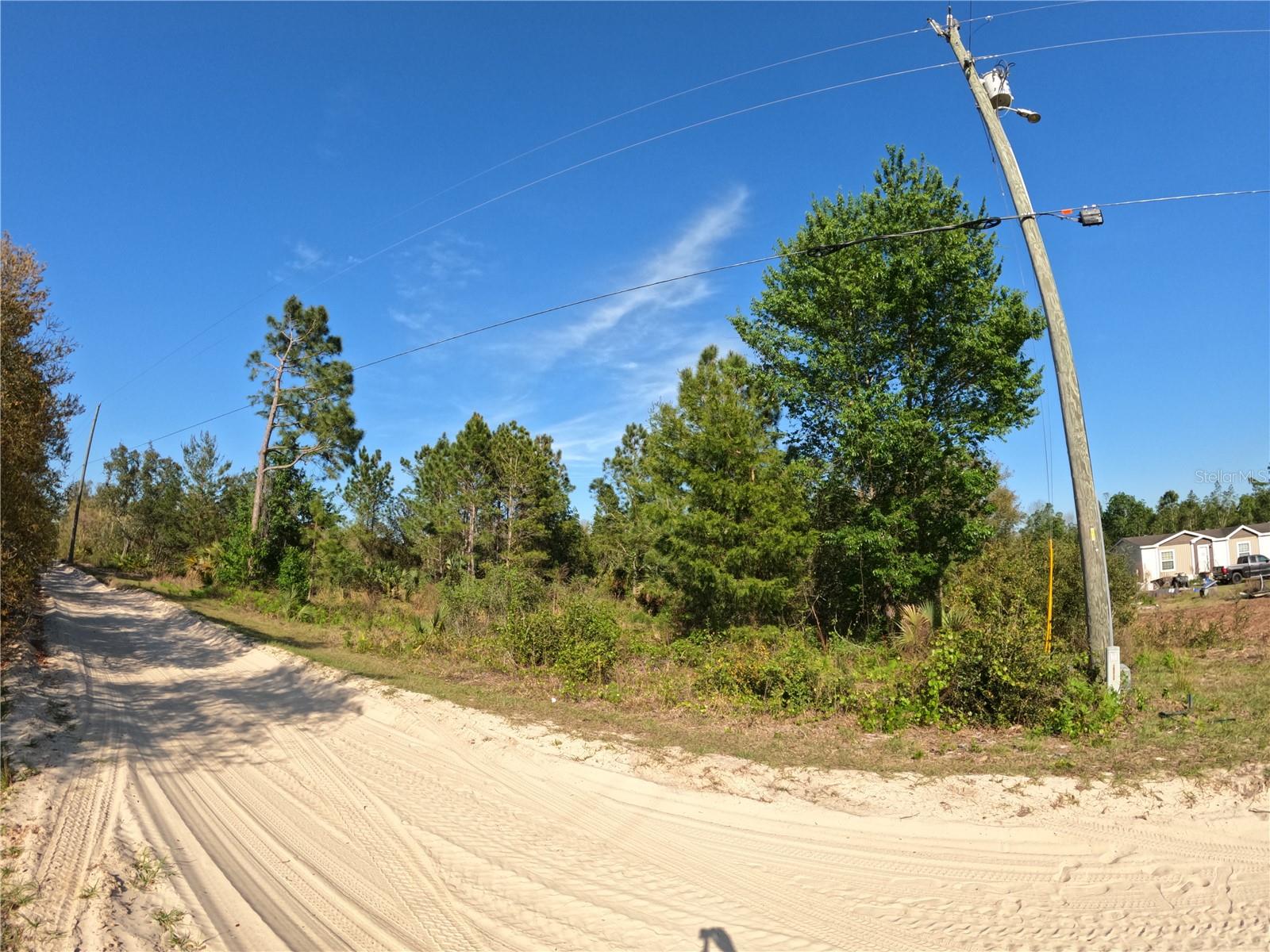 Spacious 2.45-Acre Wooded Lot in DeLand, FL – Potential Impact Fee Credit! Priced to sell! This lot is flood zone X and flood zone A. It is approximately 1/2 flood zone A. The part up towards the dirt road is flood zone X. Lot dimensions: 165 ft. x 647 ft. The dirt road frontage is 165 ft. To my knowledge, it is a buildable lot, but I encourage you to reach out to Lake County Planning and Zoning for any specific questions. It had a trailer on it from 1988 to 2007. It is my understanding that it has a well and septic on the property, however, these items were not permitted through Lake County and Lake County doesn't have record of them and I cannot speak to their condition. Feel free to have a well and/or septic company take a look. Since the lot has been built on before, it should be a candidate for an impact fee credit. Discover the perfect blend of privacy and potential with this stunning 2.45-acre parcel nestled in a quiet, country setting just minutes from charming downtown DeLand. This beautiful, wooded lot offers a serene escape with plenty of space to build your dream home or invest in future development. A strong candidate for impact fee credit, this property provides added value and flexibility. Don’t miss this rare opportunity to own a large homesite in one of Central Florida’s most desirable areas!