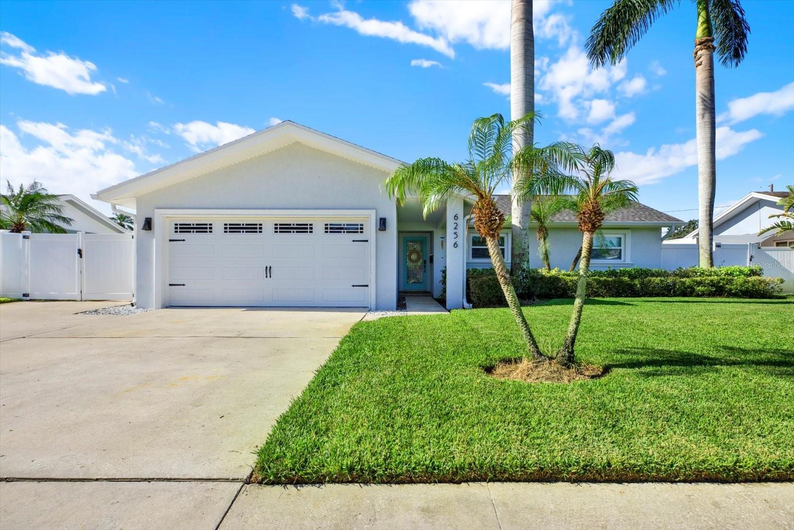 Welcome to your dream home in the heart of St. Petersburg's highly sought-after Holiday Park neighborhood! This beautifully updated 3-bedroom, 2-bathroom pool home has been meticulously designed to offer luxury, comfort, and convenience at every turn. With a private pool and spa, soaring vaulted ceilings, and modern finishes throughout, this property is the perfect blend of relaxation and sophistication. Step inside to an open, airy living space with vaulted ceilings that create a welcoming ambiance. The large primary bedroom boasts vaulted ceilings, an ensuite bathroom complete with a walk-in shower, and direct access to the pool and patio area – ideal for a quick dip after a long day. The chef-inspired kitchen, renovated in 2025, features sleek quartz countertops with waterfall edges, stainless steel appliances, large kitchen island, and contemporary recessed lighting. Perfect for entertaining or preparing everyday meals. Enjoy the ultimate Florida lifestyle with your own private pool and spa, recently re-done in 2025 including updated equipment. The pool area is fully fenced with a safety gate for peace of mind. The backyard has been freshly sodded and includes a new drainage system, ensuring your outdoor space remains pristine and dry. This home has been thoughtfully updated to ensure long-term durability and energy efficiency, including a new roof (2024), new hurricane impact windows and doors (2025), and new LVP flooring (2024). The garage has also been renovated complete with AC and insulated garage door (2025), along with newly done floors. It’s the perfect space for a home workshop or extra storage. Other highlights include a full laundry room, safety gate around the pool, new sod in the backyard, and reclaimed water sprinklers for sustainable lawn care. All bedroom closets have been upgraded with custom closet systems to maximize space and organization. The home is wired with surround sound for the perfect movie or music experience. Located in a prime spot, this home is just minutes from world-renowned beaches, including St. Pete Beach, regularly rated among the best in the country. You’ll also enjoy proximity to top-rated schools, popular restaurants, shopping, local parks, and easy access to the interstate, making this an ideal location for both relaxation and convenience. This meticulously maintained home offers everything you’ve been looking for, from modern updates to a private outdoor retreat. Don’t miss the opportunity to make this incredible property yours—schedule a showing today and see why this home truly stands out in the market!