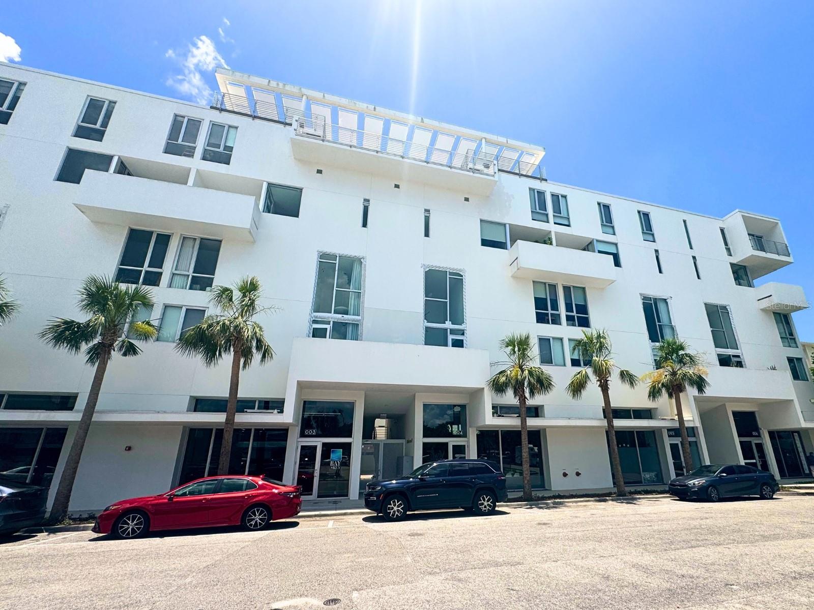 Discover modern downtown Sarasota living in this BEAUTIFULLY FURNISHED, boutique 2 BR/2.5 BA condo at Risdon on 5th, available for a 6 to 12 month lease with ALL UTILITIES INCLUDED. Completely move in ready and designed by Halflants + Pichette, the bright open layout features stone countertops, custom cabinetry, upgraded fixtures, and floor-to-ceiling impact glass framing views of the city skyline.
The spacious living and dining area flows into a gourmet kitchen with recessed lighting, a breakfast bar, and ample storage. Both bedrooms have en suite baths—including a walk-in tile shower and walk-in closet in the primary suite—and custom closet shelving for effortless organization.
Residents enjoy resort-style amenities: a heated rooftop pool, two bay-view terraces, a private Zen Garden, and secure covered parking. Situated on a quiet street in the Rosemary District, you’re just minutes from award-winning beaches, Siesta Key, St. Armands Circle, top restaurants, shops, galleries, and Sarasota Memorial Hospital. Schedule your private tour today!