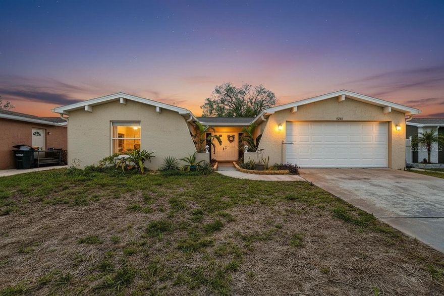 FANTASTIC OPPORTUNITY TO OWN A VERY SPACIOUS HOME OVER 1500 SQUARE FEET AND 2 LARGE BEDROOMS WITH 2 FULL BATHS AND A 2 CAR GARAGE ON A FENCED YARD WITH A BRAND NEW ROOF...INSTALLED MARCH 2026! FRESHLY PAINTED INTERIOR! WELCOMING DOUBLE DOOR ENTRY TO LARGE FOYER THAT STEPS DOWN TO THE CALIFORNIA-STYLE ENORMOUS GREAT ROOM ALL CERAMIC FLOORING AND AMAZING L STYLED FORMAL DINING ROOM WITH WOOD LAMINATE FLOORING & SLIDERS TO LANAI! STEP OUT TO YOUR WONDERFUL SCREENED PATIO/LANAI AND CHAIN LINK FENCED IN BACKYARD! FULLY EQUIPPED KITCHEN WITH REFRIGERATOR, DISHWASHER, MICROWAVE AND RANGE AND A WINDOW OVER THE SINK BRINGING NATURAL LIGHT INSIDE! STEPS FROM KITCHEN ENTER THE HUGE 2 CAR GARAGE AND LAUNDRY AREA! ON THE EAST SIDE OF THE HOME IS THE MASTER OR PRIMARY SUITE WITH ITS OWN PRIVATE EN-SUITE PRIVATE BATHROOM AND SHOWER STALL & MASTER SUITE ENJOYS SLIDERS TO BACKYARD! A HOME WITH NICE SIZED CLOSETS FOR PLENTY OF STORAGE! SPACIOUS 2ND BEDROOM WITH LARGE HALL BATH INCLUDING A SHOWER/TUB COMBO AS WELL! MOVE IN CONDITION! DON'T FORGET THIS IS LOCATED IN A NON FLOOD ZONE COMMUNITY & NO EXTRA FEES...NO HOA AND NO CDD JUST A STONE'S THROW TO US HIGHWAY 19 AND TERRIFIC EATERIES, SHOPPING AND GREAT SCHOOLS! A WELL MAINTAINED AND AFFORDABLE HOME IS JUST AWAITING THE NEXT OWNER!