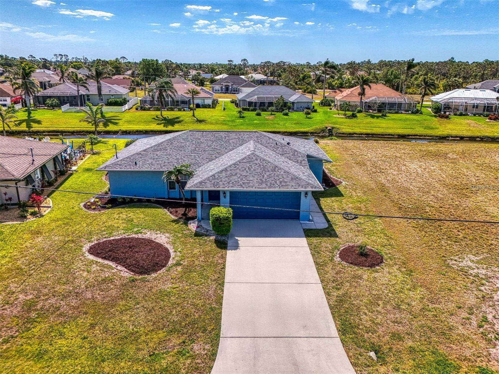Charming 3-bedroom, 2-bathroom, canal-front home in the highly sought-after Rotonda West Broadmoor neighborhood! With a spacious floor plan and a brand-new roof from 2023, this home is sure to impress. Home sits on in X500 flood zone and per seller, it has never flooded before! Located just moments from local parks, shopping, schools, and a variety of recreational activities, this property truly offers it all. Step inside and be greeted by the bright, open design of the great room, where large windows flood the space with natural light. Beautiful tile flooring flows throughout this area, creating a seamless and inviting atmosphere. The dining area features soaring cathedral ceilings, adding to the sense of space, and a handy coat closet for extra convenience. Sliding doors from the dining room lead to a large, screened lanai, offering breathtaking views of the freshwater canal—a perfect place to relax or entertain while enjoying the serene surroundings. The well-appointed kitchen is a dream, complete with a breakfast bar for casual dining or mingling with guests. Featuring stainless steel appliances, a built-in oven, a newer double sink with faucet, and white cabinetry, this kitchen provides plenty of storage and counter space for all your culinary needs. A spacious closet pantry ensures everything has its place. The master suite is a peaceful retreat, with two walk-in closets providing ample storage space. The master bath boasts a walk-in shower, adding a touch of convenience and style. The two guest bedrooms are equally roomy and also feature walk-in closets. The guest bathroom is equipped with a tub/shower combination, perfect for relaxing after a long day. Additional features of the home include an oversized two-car garage with epoxy flooring, a side door for easy access, attic storage, and the laundry room complete with a washer and dryer. The garage door and opener were replaced in 2023. Enjoy peace of mind with Bahama shutters, hurricane shutters, and a Rain Bird irrigation system. The home also includes a 25x8 concrete patio outside the lanai—ideal for grilling or simply enjoying the outdoors. This home has been meticulously maintained with several updates, including new carpet in 2024, updated plumbing throughout in 2019, and a water heater from 2020. The exterior was recently painted, and the landscaping has been professionally designed for curb appeal. Rotonda West is a vibrant community with 26 miles of canals, ponds, and lakes teeming with wildlife and fish. For a low fee of just $190 per year, you’ll enjoy access to this beautiful and well-kept neighborhood. With five golf courses nearby and the sandy white beaches of Boca Grande just a short drive away, there’s always something to enjoy. Don’t miss out on the opportunity to own this incredible home. Call today for your private viewing—this one won’t last long!