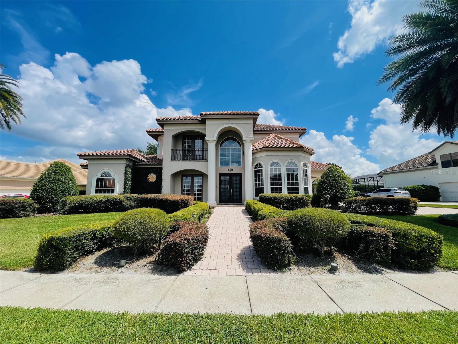 Stunning Elegant, Professionally Decorated, Reiche Silliman built, 5 bedrm, 4 & 1/2 masterpiece nestled on spacious lot . Master bedrm & guest bedrm downstairs, 3 bedrooms & bonus rm upstairs. Crown moulding, 8 ft doors & 8" base boards in living area. Open kitchen features granite counter-tops, gas cook top & new top of line stainless steel appliances w/exception to the refrigerator, along w/ tasteful 45" cabinetry. The family rm features 20+ceiling w/built in wood cabinetry, French doors leading to the patio & pool. Expansive master bedrm features spacious double walk-in closets w/closet organizers. Master bth features whirlpool bath, sep walk-in shower & dual vanities. Large upstairs bonus rm offers flexibility as a game rm or home theatre. Custom Drapery throughout.Sparkling pool & spa like backyard including a fenced dog run. Pool & Patio area is screened with brick pavers, gas hook up & private half bath. This home complete w/ON Q home audio video lighting control system. Energy Efficient film on windows. Private gated community is in the heart of Dr. Phillips. Away from Central Florida's most upscale shopping, restaurants, theme parks & major rds. Kensington is zoned for 3 outstanding "A" rated schools.