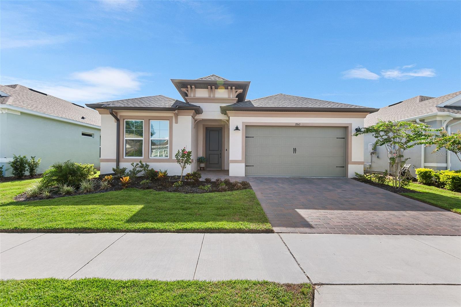 This stunning home, meticulously upgraded to embody luxury, welcomes you with low-maintenance, high-end tile flooring flowing seamlessly throughout. The gourmet kitchen, a chef’s dream, boasts top-of-the-line stainless steel appliances, including a built-in oven and gas cooktop, anchored by a massive oversized island adorned with exquisite stone that extends to the matching backsplash. The open-concept design effortlessly connects the kitchen to the dining space and living room, perfect for entertaining guests or enjoying quality time together. Just off the living room, a door leads to a spacious screened-in paver patio, complete with a remarkable outdoor kitchen featuring a beverage fridge, sink, and gas grill, ideal for al fresco dining. The expansive master bedroom serves as a serene retreat, complemented by an ensuite bath showcasing dual sinks, a striking stone countertop, modern fixtures, and a luxurious walk-in shower. Nestled in a vibrant community, this home offers access to an array of amenities, including tennis courts, a pool, clubhouse, shuffleboard, and more, with the added perk of discounted play at the renowned Mystic Dunes Golf Course. Beyond the community, you’re just minutes away from dining, retail, entertainment, and the magic of Disney, ensuring every convenience is within reach.