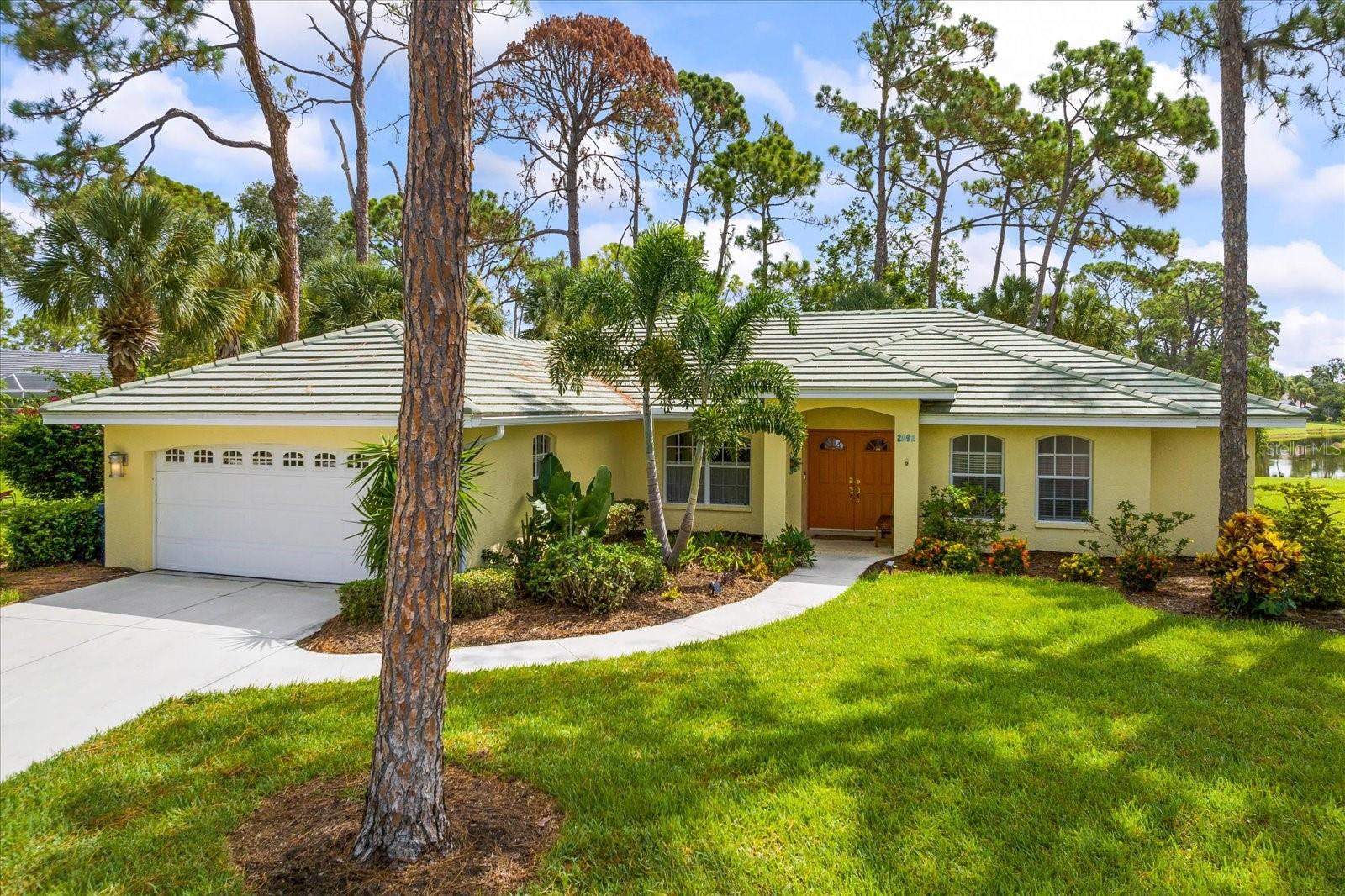 Discover your hidden oasis in the heart of the maintenance-free Calusa Lakes neighborhood with this impeccably updated home. As you step into the gated community, be mesmerized by the enchanting waterfalls that welcome you with their majestic charm. Inside, a world of comfort and elegance unfolds. This 3-bedroom, 2-bathroom, 2-car garage home boasts a thoughtfully designed split floor plan that enhances privacy. The open-concept kitchen seamlessly flows into the living space, creating a harmonious blend of functionality and style. With vaulted ceilings and contemporary light fixtures, the home exudes a modern yet inviting ambiance. Every detail has been carefully considered, from the large tiles underfoot to the newer roof overhead. Your sanctuary awaits in the primary bathroom, where an updated walk-in frameless glass shower awaits with a ceiling rain shower head – a truly indulgent experience. Modern Vessel sinks add a touch of sophistication, while a linen closet and a separate enclosed space for the latrine offer practicality and privacy. The guest bathroom is no less impressive, featuring a bathtub with ceiling rain and wall shower heads, making every bath a soothing escape. But it's the outdoors that truly captivate – an expansive screened patio stretches along the entire back of the house, shaded by towering pine trees. Here, you can bask in the tranquility, whether you're hosting gatherings or simply savoring the serene lake view that leads to the lush greens of a meticulously maintained golf course.Convenience meets leisure in this prime location. A short stroll away, Woodland Trails beckons with its social neighborhood gatherings. The heated community pool and hard-tru tennis courts are at your disposal, and an optional golf membership opens up endless opportunities for recreation. Embrace an active lifestyle with the Legacy Trail for biking and walking, while Oscar Scherer Park, shopping, medical facilities, and cultural activities in Venice and Sarasota await your exploration.And let's not forget – Nokomis Beach is just two stop lights away, making coastal getaways a breeze. With a newer roof and an A/C system freshly installed on July 31, 2023, this home seamlessly blends comfort, style, and practicality. Embrace the Calusa Lakes way of life – where modern living meets natural beauty, and every day feels like a retreat.