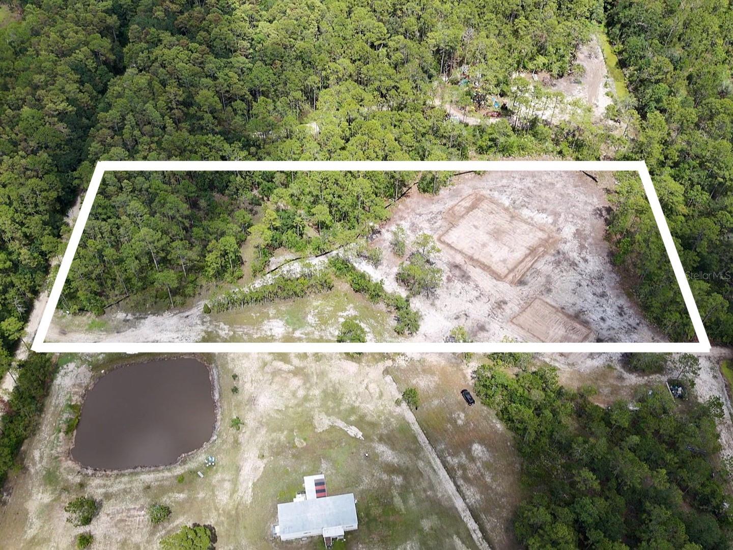 RARE OPPORTUNITY!! Now is your chance to take advantage of building your custom dream home on a CLEARED vacant lot in New Smyrna Beach, Florida! Zoned A-1 for residential and agricultural. 5 acres of cleared, tested, permitted, dirt filled, utility-ready land - primed for someone to come in and just build a home with option to add warehouse/workshop. Both areas for home and warehouse with plans have been dirt filled and raised. With 330 feet of frontage, the driveway to the back of the lot has been leveled off and brings you to the huge open canvas to customize your ranch style home. Internet was just installed nearby. Electric and water nearby. Pond is partially owned by neighbor. Jump on this rare opportunity to be tucked in a secluded area just minutes to New Smyrna Beaches, dining, shopping, and entertainment.