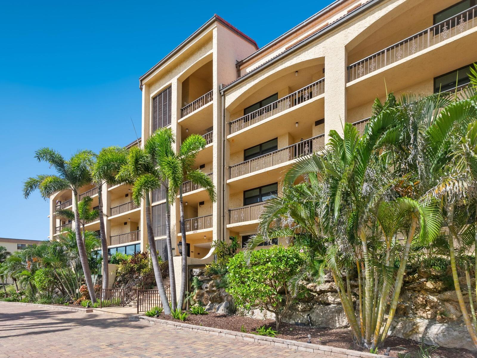 Discover this beautifully updated two-bedroom, two-bath residence in Tortuga, one of Siesta Key’s beloved beachfront communities. Step inside this 1,232-square-foot retreat and immediately notice thoughtful touches throughout. The open-concept layout seamlessly connects the stylish kitchen featuring Whirlpool stainless steel appliances, granite countertops and generous cabinetry. It seamlessly opens to the dining area with plenty of space for meals with friends and family, and the spacious great room, complete with crown molding and tons of natural light, with sliders to the versatile sunroom. Enjoy it as a screened lanai to capture fresh Gulf breezes and nightly sunsets or close the sliding glass doors for an air-conditioned oasis with a partial Gulf of Mexico view. A built-in dry bar makes this space ideal for entertaining. Both bedrooms are positioned in a desirable split plan, each offering its private en-suite bath with modern fixtures and granite vanity tops, ensuring comfort and privacy for you and guests. Practical conveniences elevate everyday living — including in-unit laundry, covered parking to keep your car cool, secure building access with an elevator and extra storage for all your beach essentials. Tortuga’s resort-style amenities include a heated indoor/outdoor pool, beautifully maintained grounds, covered walkways, ample guest parking, and a welcoming club room for gatherings and community events. Beyond your doorstep, Turtle Beach awaits nearby, while Siesta Key Village’s restaurants, shops and activities are a short trolley ride away. From local arts and culture to boating, golf, pickleball and Sarasota’s vibrant year-round calendar of events — this is your gateway to the best of Gulf Coast living. Plus, with Sarasota-Bradenton Airport just minutes away, coming and going is a breeze.