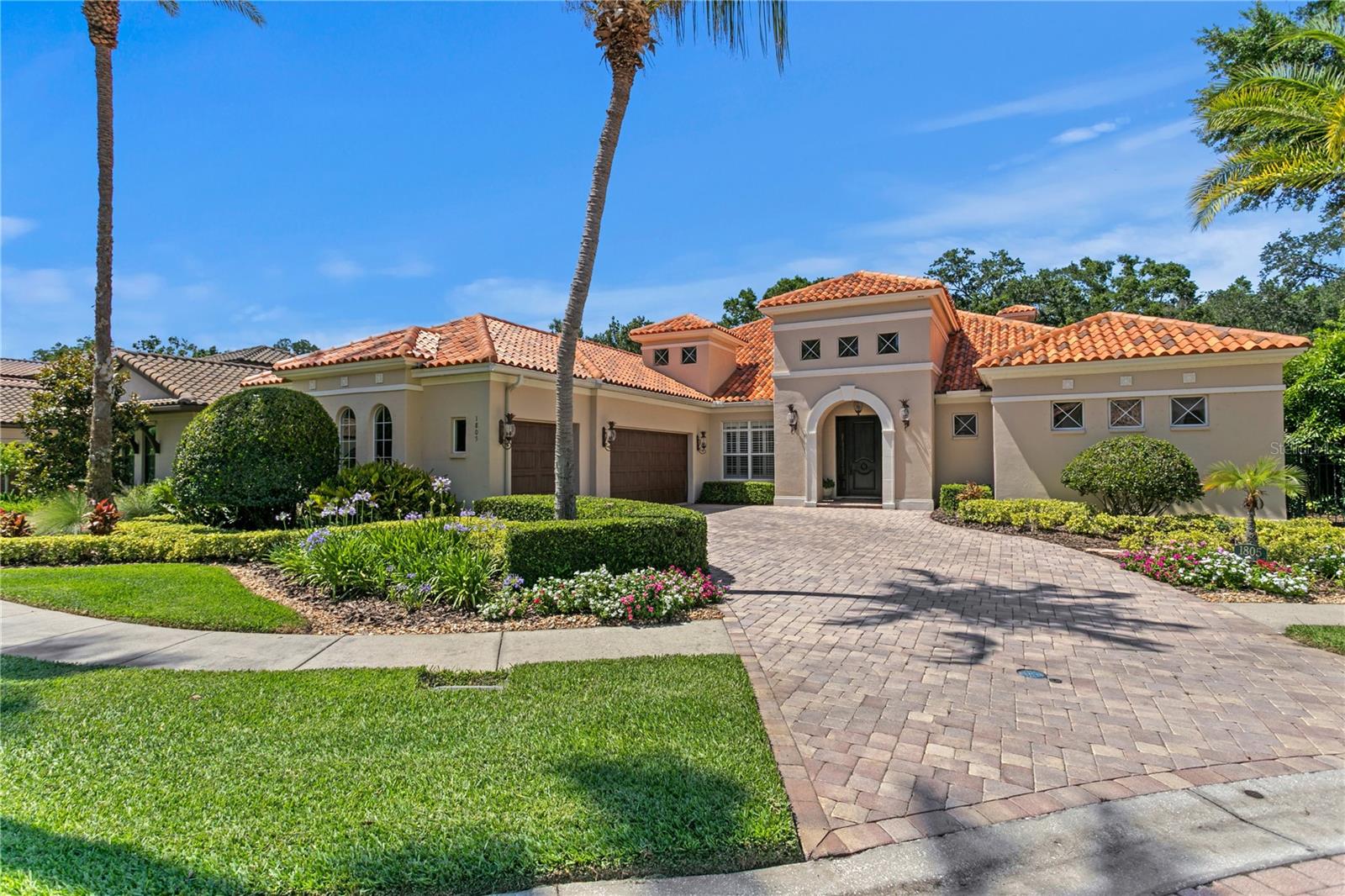 Welcome to this stunning one-story home in the gated community of Bella Vita. Custom designed with premium finishes and meticulous attention to detail, this 3,962 Sq Ft residence offers luxury living at its finest. Ideally located on a quiet cul-de-sac, the home features a beautiful conservation lot—providing privacy and a serene natural backdrop. From the moment you arrive, you’ll be impressed by the beautifully landscaped grounds, the brick paver driveway, and the classic clay tile roof that enhances the home’s elegant curb appeal. Inside, the spacious layout includes 4 bedrooms, 3.5 bathrooms, and thoughtfully designed living areas that flow seamlessly into an extraordinary outdoor living space. The open floor plan is basked in sunlight and features travertine floors, designer lighting, custom draperies, crown molding, plantation shutters all which enhance this gorgeous home. The gourmet kitchen features stainless steel appliances, a 5-burner gas range, a Miele built-in coffee machine, marble countertops, built-in desk, and a large kitchen island with seating for four - ideal for casual gatherings. The kitchen opens to the family room and the retractable sliding glass doors from the family room extends your living space. The luxurious primary suite is a private retreat, featuring a luxurious spa-style bathroom with his and her vanities with quartz countertops, designer mirrors and lighting, and a custom California closet. Three additional bedrooms are thoughtfully designed, each offering comfort, style, and plenty of room for family and guests. The outdoor living areas are truly extraordinary and feature a screened patio with a swimming pool, fireplace, outdoor kitchen, built in movie screen and an oversized patio. The backyard is complete with a private path that leads to an outdoor fire place that is the perfect spot to gather and entertain. This gated community is centrally located in Tampa & offers a wonderful lifestyle that is convenient to Carrollwood Day School, Avila & all major highways.