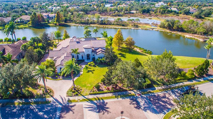 NEW PRICE!!! IMMEDIATE AVAILABILITY!!! WINTER IN FLORIDA!!! Just imagine you are entering your private villa on one of the secluded coves of Lake Como, yet you are in The Lake Club Phase I where each home offers a unique architectural style. Here you will find a variety of architectures from Tuscan to Georgian to Key West to Contemporary including custom reflecting the distinct and distinguishing imagination of builder and homeowner. Now Enter into your John Cannon exceptional and meticulously cared for 4-bedroom 3 bath lake front home on over 1/2 acre with outstanding curb appeal. This home has been remodeled and upgraded to meet the requirements of today’s discerning homeowner. The open floor plan is perfect for entertaining family and friends, yet the layout affords privacy for both homeowner and guests with a separate en suite bath in the casita style front bedroom with a separate entrance. The 3rd & 4th bedrooms share a full bath in rear of home with easy access to the spacious outdoor living area, outdoor kitchen and water featured pool and spa, all complemented by the expansive lake and preserve views. For the homeowner entertaining is made easy with the generously appointed kitchen which becomes the center of activity in the home. Your gourmet center comes with appliances from Wolf including SS 6 burner cooktop, SS convection MW, wall oven and DW, Sub-Zero built-in refrigerator, ample floor to ceiling wood cabinets and an oversized center island with waterfall ends, built in wine refrig, quartz countertops and can accommodate bar seating. This center provides seamless access to Family, Dining and Living rooms making it a delight to entertain. The home features are just endless and include featured high ceilings, ample crown and trim, electric fireplace in Living Room, arched solid wood speakeasy like front door, all on a lushly landscaped lot with mature trees. Wait there is much more like engineered hardwood flooring throughout, glass sliders with disappearing corner, stone wall has built in 80" television on a power adjustable mount and electric fireplace in Family Room. For the homeowner after a full day of entertaining or just relaxing by the pool, a retreat awaits in the primary bedroom with 2 walk-in closets, separate coat closets, a completely upgraded primary bathroom with separate vanities and generous state of the art lighting. Top all this off with a separate Den/Office off the primary bedroom affording maximum privacy for either relaxing or conducting business.  For the more infrastructure conscious there are impact resistant windows, whole house gas generator, multi zone separate A/C systems, 3 car oversized air-conditioned side entry garage, a water softener, water filtration system, tankless hot water system, recently painted exterior and newly screened lanai. Every corner of home both inside and out has been touched over the last few years making it like new. Don't miss out in being a resident at The Lake Cub Phase I, one of the most sought-after communities in Lakewood Ranch where the amenities include tennis, pickleball, resort style pools, fabulous dining at Clubhouse, dog park, playground and more. Optional membership in Lakewood Ranch Country Club with 4 golf courses is only a golf cart trip away. Shopping and dining options are numerous only a short drive to UTC Mall and downtown Sarasota, and some of the best beaches on the Gulf of America, come live the dream today!!! One photo is virtually staged...