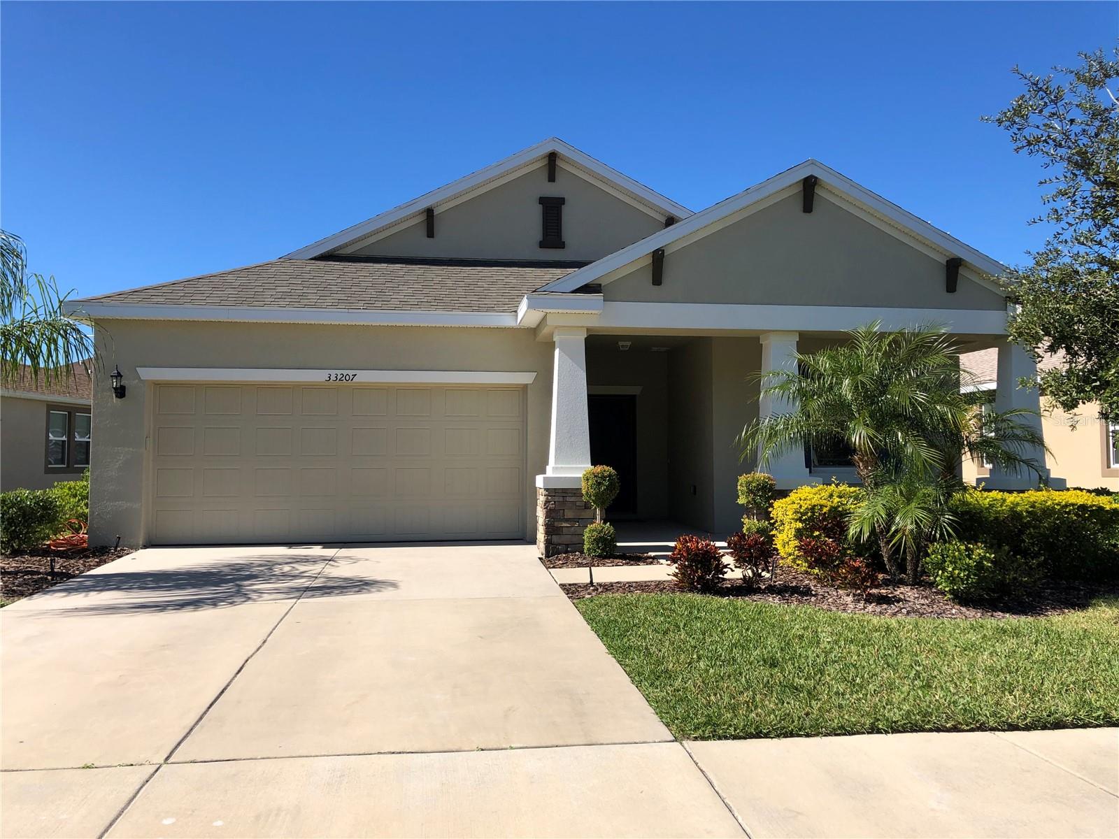 Wesley Chapel - Watergrass! This immaculate 4 bedroom, 2 bath home is open and spacious with family room open to the kitchen/dining room, and beyond, with sliding glass doors opening onto a covered lanai. Kitchen has beautiful cabinets, stainless appliances, center island, and gorgeous zodiaq countertops. Master suite features a large walk-in closet & a master bath with granite countertops. The other 3 bedrooms are split from the master and share a hall bath with granite countertop. Brand new flooring in bedrooms; no carpet to deal with! The outstanding community amenities include a clubhouse, pool, tennis court, playground, multi-purpose field, & onsite elementary school. Conveniently located to all that Wesley Chapel, Dade City and Zephyrhills have to offer - including incredible dining, shopping and recreation choices! Don't miss out!