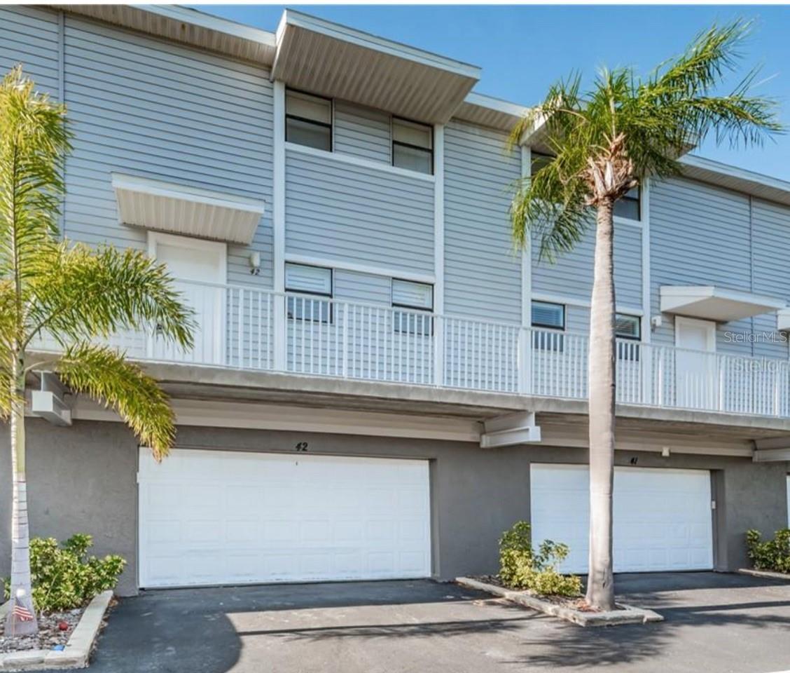 : New Roof installed in May 2025! Welcome to your dream beach retreat at Seashell of Indian Shores, a rare no-minimum rental community—perfect for generating year-round income or enjoying as a personal getaway! This beautifully renovated townhome offers 2 spacious bedrooms, 2.5 bathrooms, and an oversized 2-car garage, providing 1,225 sq. ft. of stylish coastal living just steps from the Gulf of Mexico. Sold fully furnished and move-in ready, this home boasts luxury vinyl plank flooring throughout, new vanities, doors, and a brand-new A/C (2024). The open-concept living and dining area flows effortlessly onto a large private deck, perfect for soaking in the tranquil Gulf breezes and enjoying the lush tropical surroundings. Upstairs, the oversized primary suite features a walk-in closet and ensuite bath, while the guest bedroom offers a spacious closet. Seashell’s resort-style amenities include a heated pool overlooking the Intracoastal Waterway, a fishing dock, and a kayak launch, allowing you to fully embrace the beach-to-bay lifestyle. With pet-friendly policies and no rental restrictions, this property is a prime investment opportunity or the perfect island escape. Restaurants, shops, and entertainment are just a short stroll away, placing the best of Indian Shores at your fingertips. Whether you're looking for a turnkey vacation rental, a second home, or a full-time coastal oasis, this is a rare chance to own in one of Florida’s most desirable beach communities. Don’t wait—schedule your private showing today and start living the beach life!