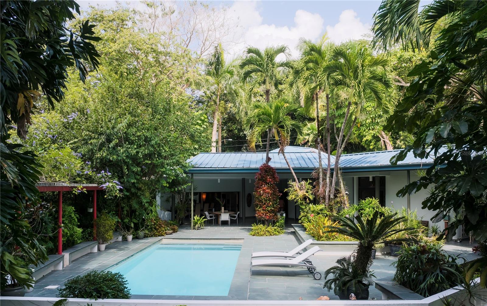 Beautiful and spacious home, countryside private community at 10 minutes from the city. The house is surrounded by mature and lush vegetation. The house includes 4 bedrooms, 4 1/2 bathrooms, flex room, outdoor terrace, pool, ample living, dining and kitchen area all connected to the outdoor terrace, family room, office, study, entertainment room, power generator, water cistern, picketball court. The pool is engulfed within nature and is a private oasis, providing the perfect space to host family and friends. 7500 sf interior plus 2500 terrace, 1.5 acres lot. Community with controlled access and 24/7 security. Very private community.