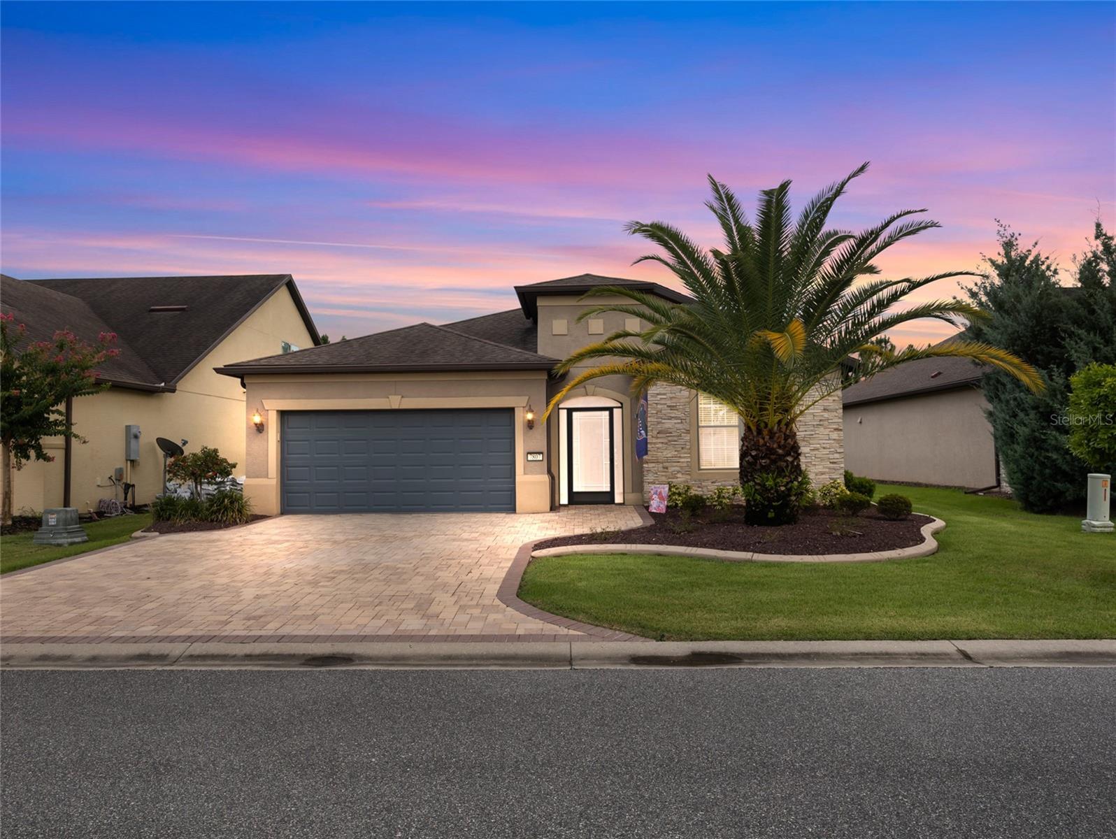 Discover effortless living in this beautifully maintained Abbeyville model with a sunroom, ideally nestled in the serene, resort-style Stone Creek by Del Webb community. The exterior is aesthetically pleasing, showcasing upgraded landscaping, hardscape, stonework, a screened front porch and a paver driveway and walkway. Inside, enjoy tile flooring throughout the main living areas and bathrooms, illuminated by ceiling fans and natural light through tasteful blinds. The chef's kitchen boasts modern stainless steel appliances, stunning staggered cabinets, sleek granite countertops, an elegant backsplash, under-cabinet lighting, and eye-catching pendant fixtures, making it perfect for every culinary adventure. Retreat to the spacious primary suite, complete with a tiled shower, granite vanity, and a generous walk-in closet. The guest bath offers a tiled tub and granite countertops for added comfort. The versatile flex room adapts to your needs, making it perfect as a home office, den, or creative space. The laundry room promotes added convenience with its large storage closet. Outside, unwind year-round on your screened, covered lanai, ideal for savoring morning coffee or evening relaxation. Additional features include a water softener, sliding glass doors, and an extended 2-car garage. Stone Creek offers a wealth of nearby amenities, including golf courses, pools, fitness centers, and social clubs. Don’t miss this opportunity. Schedule your private showing and experience resort-inspired living today!