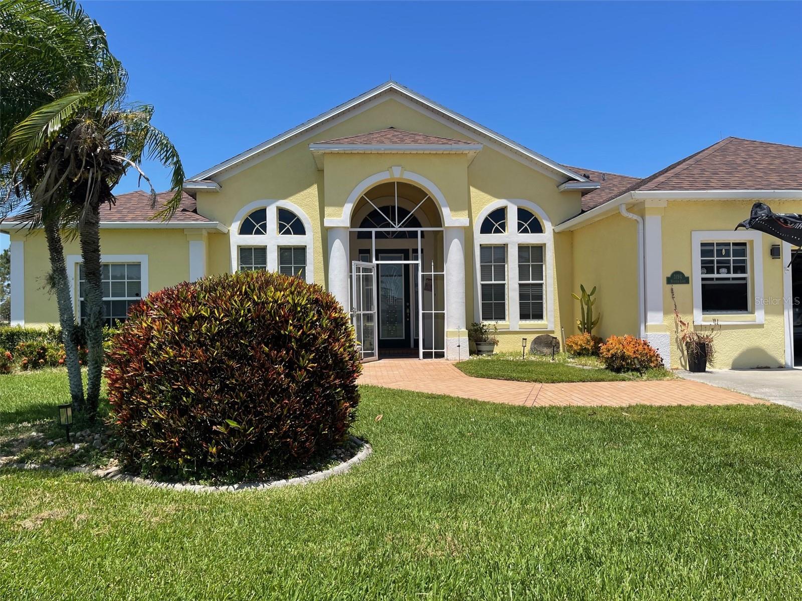 Enjoy this amazing home! 4 bedroom 2 bath POOL home, 2 Car Garage & Royal Golf course view. No rear neighbors! Formal dining, living room, kitchen and dinette over looking great room. Split bedroom floor plan, inside laundry room, updated kitchen appliances, custom cabinets, pantry, backsplash, granite counter tops and extended breakfast bar. Light and bright great room with large sliders leading to screened lanai. Imported Italian marble flooring and decorative plant shelves. Main bedroom with tray celling, french doors to lanai with built out closet. Main bath with dual vanities, garden tub and walk-in shower. Outside retreat has large screen enclosure, encompassing gorgeous solar heated pool, 7 Foot at deep end, sun shades for privacy, pool cleaner, fully tiled with child safety fence and outdoor hot/cold shower!
Garage extended an additional 5 feet for added storage. Central vac, decorative front door - Truly exquisite amenities await you.