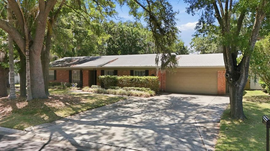DESIRABLE LAKE MAGDALENE AREA in small, established community with NO required HOA!  Spacious 4/2/2 on beautiful tree-lined street with large lots. Attractive curb appeal with stately shade trees, red brick & stucco exterior, covered entry and decorative shutters. An easy commute to Tampa Airport, downtown and more.  You're sure to love the HUGE, FULLY FENCED BACK YARD!  Lots of potential to make this home your own...update the current floor plan if desired or possibly create a more open great room concept by removing interior walls.  Built in 1973, this concrete block home offers a LIVING ROOM with built-in cabinets and DINING ROOM with wainscotting located at the front of the house.  An OPEN KITCHEN with BREAKFAST NOOK is adjacent to the FAMILY ROOM in the center.  Plenty of space for the family to spread out!  Large sliding glass doors in the family room lead out to the OVERSIZED COVERED, SCREENED BACK PATIO and MASSIVE BACK YARD featuring TWO STORAGE SHEDS and lots of room to run and play.  Three bedrooms, including the Primary with en-suite bathroom, are down the hallway to the left along with the second bathroom.  A fourth, OVERSIZED 4TH BEDROOM/FLEX SPACE is off the kitchen and can be used as an office, den, playroom, fitness room, etc.  CROWN MOLDING and LAMINATE WOOD FLOORING adorn the living areas and Primary bedroom.  Tile floors in all wet areas and the 4th bedroom.  Carpet only in 2 bedrooms.  Beautiful PLANTATION SHUTTERS cover the window in the BREAKFAST NOOK which OVERLOOKS the backyard. New roof in 2019, Exterior paint & new AC in 2020. An easy commute to Tampa Airport via the Veteran's Expressway and a short drive to I-275 to get to downtown or over the bridges to the beaches.  If you're looking for a property with strong bones, great curb appeal, and significant upside potential, this is an excellent opportunity for you!