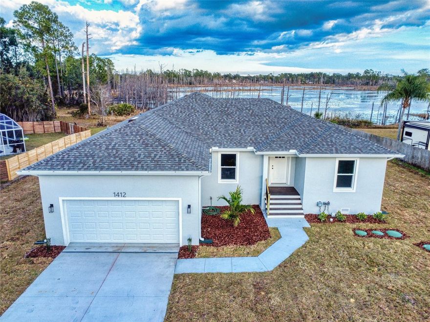 This stunning Lake Front, 3-bedroom, 2-bath NEW CONSTRUCTION home showcases beautiful upgrades throughout and a thoughtfully designed open-concept floor plan, perfect for both everyday living and entertaining. The spacious primary suite offers a private retreat with a well-appointed en-suite bath. Step outside to a large back porch overlooking serene Lake Clara, ideal for relaxing, dining, or hosting gatherings. Enjoy fishing and kayaking from the privacy of your own backyard, embracing true waterfront living. Offering peace of mind with a FEMA-approved house and the flexibility of a large parcel with ample space for RV and boat storage, this property has no HOA restrictions. A true blend of modern comfort, functionality, and freedom.