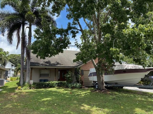 Opportunity is knocking on one of Pinellas County’s most desirable waterways! Just six houses from open Lake Tarpon, this two-story waterfront property sits on a wide, straight canal with a quick, easy ride to the lake. Your own private dock means boating, kayaking, fishing, and jet skiing are right outside your back door. A large covered back patio overlooks the canal — the perfect spot for entertaining friends, enjoying outdoor dining, or simply relaxing while watching the water. With the potential to be approximately 2,800 sq. ft. of living space based on original plans (per seller), this home is truly a blank canvas — the perfect chance to create exactly what you want in a lakefront retreat. Whether you envision a modern coastal showplace, a warm and rustic lodge, or an entertainer’s paradise, the possibilities are endless. The project was never completed, giving you a rare opportunity to start fresh with your own style and layout. Thanks to Lake Tarpon’s managed water levels, this property has never experienced flooding from storms, offering added peace of mind for your investment. Only 10 minutes from Downtown Palm Harbor with its great bars, restaurants, and shopping. Close to some of the top beaches in the country and just 10 minutes from the famous Tarpon Springs Sponge Docks. Located in a top-rated school zone (including the sought after Palm Harbor University High School) and just minutes from US Highway 19, this home offers both convenience and an unbeatable lake lifestyle. Make this property your masterpiece — where every day feels like a vacation!