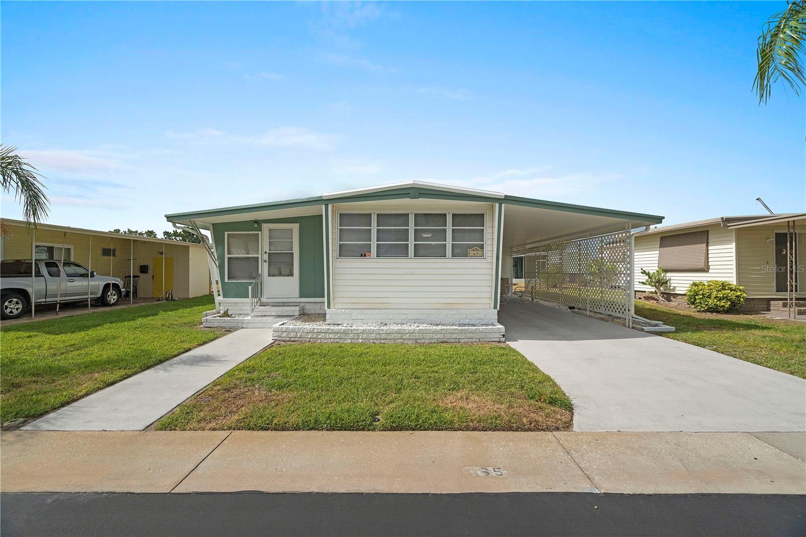 Great Location! This Charming 2 Bedroom/1 Bath Home Is Located in The Very Popular 55+ Community of Tarpon Shores MH Village Where ***YOU OWN YOUR OWN LAND***THE SHARE PRICE FOR THE LAND IS $40K; INCLUDED IN THE LIST PRICE AND CAN BE FINANCED THROUGH THE HOA*** This Home has been RECENTLY UPDATED and is MOVE-IN READY with 924 HEATED SQUARE FEET and HAS LOTS OF LIVING SPACE. The Kitchen Is Open to The Living Room/Dining Room and The Dining Room Is Open to The Large Florida Room Making It Great for Entertaining. It Is Light and Bright with Lots of Natural Light. All New Flooring and The Floors Are Solid! The Jack and Jill Bathroom Is Completely Redone and Is with A Step-In Shower Where You Will Bathe in Luxury with A 6 Jet Stainless Steel Shower Panel System with Rainfall Shower Head And Handshower Wand. The Kitchen Is Light and Bright and Comes with A New Refrigerator, Range, And Range Hood. There Are Plenty of Closets and Lots of Storage Space and The Shed Provides Additional Storage. RECENT UPDATES: KITCHEN AND BATHROOM UPDATED, RECENTLY PAINTED INTERIOR/EXTERIOR, ROOF NEW IN 2023; HVAC NEW OCT 2019, ALL NEW FLOORING, NEW REFRIGERATOR, RANGE, AND RANGE HOOD. LOW TAXES AND NOT IN A FLOOD HAZARD ZONE. TARPON SHORES OFFERS MANY AMENITIES WHICH INCLUDES A LARGE CLUB HOUSE WITH A HEATED POOL, KITCHEN, LAUNDRY FACILITY, LIBRARY, CARD ROOM, BILLIARDS, COVERED SHUFFLEBOARD COURTS, BOCCI BALL COURT, HORSESHOE PITS, MONTHLY NEWSLETTERS, NUMEROUS ORGANIZED ACTIVITIES, AND GOLF & BOWLING LEAGUES. ****THE LOW MONTHLY FEE OF $260 A Month INCLUDES: LAWN MAINTENANCE, TREE TRIMMING, WATER, SEWER, TRASH/RECYCLING PICK UP, EXPANDED CABLE WITH PARK INFO CHANNEL, AND INTERNET.**** No Pets Allowed Except For Service or Emotional Support Animals. Proper Documentation Is Required. Located Near Publix Shopping Center and Walmart Shopping Center. Minutes To the World-Famous Tarpon Springs Sponge Docks, Two Gulf Beaches and Parks, Golfing, The Historic District with Quaint Shops, Restaurants, Art And Antiques, Entertainment, Churches, Medical, A Hospital And Every Convenience. You Are Going to Love Your New Home in Beautiful Tarpon Shores! **Ask About Financing**