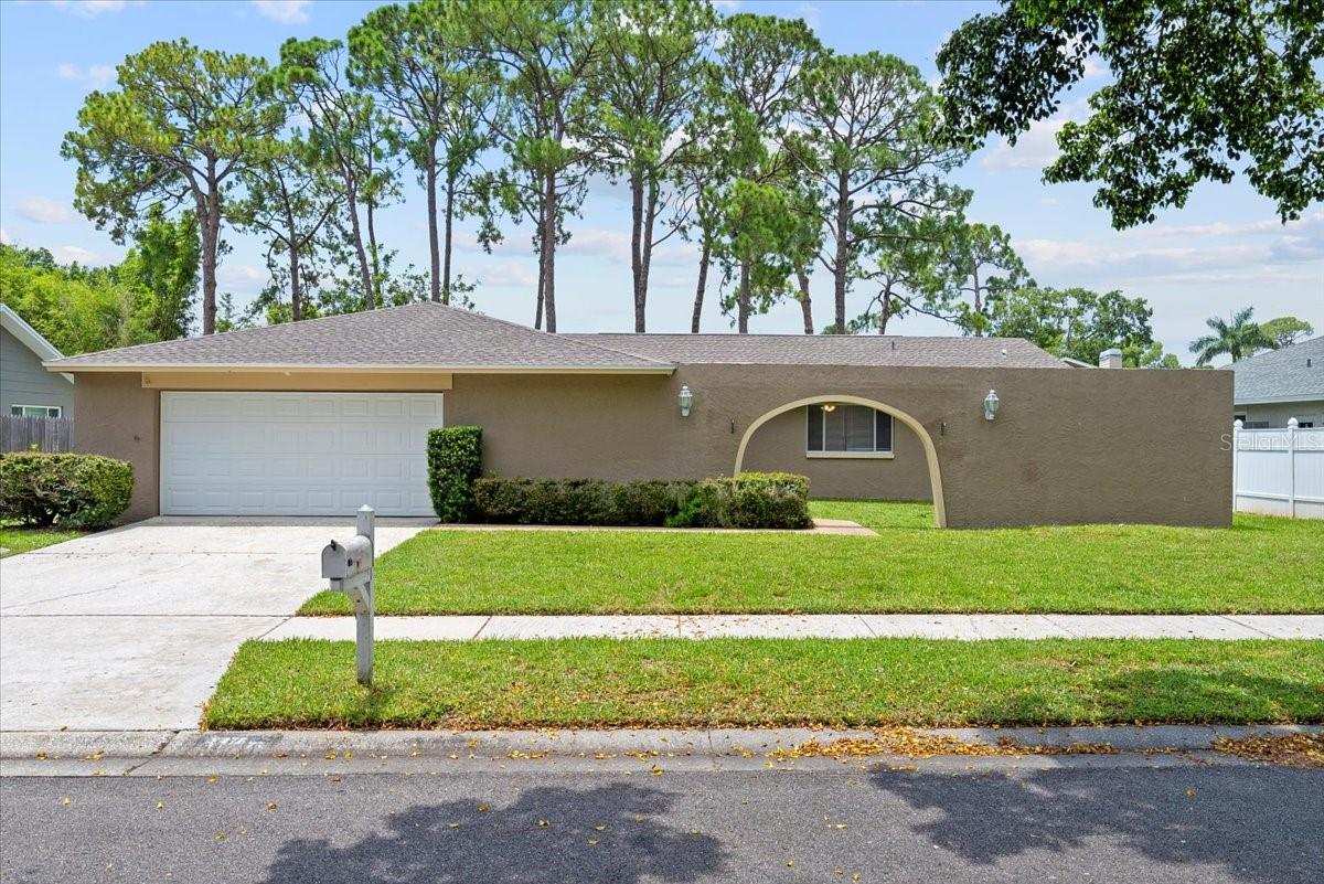 Newly Renovated 4-Bedroom Home in Prime Clearwater Location! Welcome to this STUNNING and SPACIOUS 4-bedroom, 2-bathroom home located in one of Clearwater’s most sought-after residential neighborhoods. This bright and open floor plan has a sizable living and dining area in addition to a breakfast nook and family room – complete with decorative only fireplace! The luxurious primary suite features patio access, a walk-in closet, and a beautifully remodeled SPA-INSPIRED ENSUITE with double sinks and an incredible walk-in shower. And there are 3 more generously sized secondary bedrooms with ample closet space - perfect for guests, home office or whatever you need. And it’s a chef’s dream in the GOURMET-INSPIRED RENOVATED KITCHEN featuring stainless steel appliances, granite countertops, soft-close crisp white cabinetry, and a large breakfast bar. And no carpet here – beautiful wood-like vinyl flooring has been installed in most areas. This home sits on almost a quarter of an acre with a HUGE FENCED BACKYARD and screened backyard lanai - perfect for entertaining, barbeques and to bring along your little furry family member! And relax on the weekends because LAWN MAINTENANCE IS INCLUDED! An indoor laundry room with a full-size washer and dryer is included and attached two-car garage with extended well and driveway for additional parking. Feather Sound is a quiet, friendly neighborhood with mature landscaping and pride in ownership. Just minutes to award-winning beaches of Clearwater, high-end shopping, dining, downtown St. Pete, and convenient access to Tampa International Airport, St. Pete–Clearwater Airport, and major highways. Whether you're commuting to work, enjoying the beach lifestyle, or exploring everything the Gulf Coast has to offer, this home puts you in the perfect location.