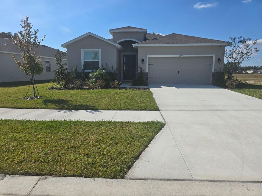 BRAND NEW HOME for RENT, Welcome to the Deerbrook community, located off US-41 in Land O’ Lakes. This 4-bedroom, 2.5-bathroom home features a bright, open-concept floor plan designed for effortless entertaining and modern Florida living. The heart of the home is a chef-ready gourmet kitchen, featuring elegant quartz countertops, a designer backsplash, stainless steel appliances, and a large island perfect for casual seating. Recessed lighting and a spacious walk-in pantry complete this ideal gathering space. Modern ceramic tile flooring flows seamlessly through the kitchen, living, and dining areas, creating a functional and stylish environment. The thoughtfully designed split floor plan ensures maximum privacy. A spacious primary suite offers a true sanctuary, with two walk-in closets and a spa-like ensuite bathroom, featuring double vanities, a walk-in shower, and a luxurious soaking tub. Three additional bedrooms are situated towards the front of the home—one perfectly sized for a nursery or home office—providing comfort and flexibility for family or guests. Step outside to your ideal outdoor oasis: a covered lanai and private. This Location will be a close distance to walking trails and the Suncoast Parkway biking paths, as well as nearby shopping and dining! The Tampa Premium Outlets and Wiregrass Mall are less than 30 minutes away, providing additional shopping and entertainment. Downtown Tampa is just 23 miles away, as is Tampa International Airport. Deerbrook will feature a lineup of our Express, and Tradition floorplans, providing a home for every stage of life! The area is zoned for highly rated Pasco County schools and is just minutes away from US Hwy 41