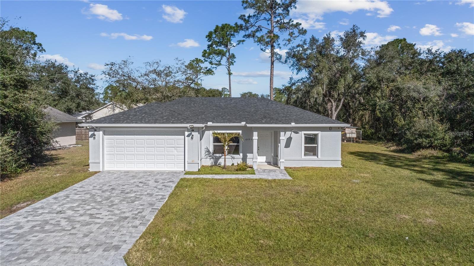 This property qualifies for lender credit through the preferred lender. Modern Home in St. Cloud – Spacious Lot with No Restrictions Welcome to 6495 Eve St, Saint Cloud, FL, a nearly new home built in 2022, located in the NO HOA, NO CDD community of New Eden. This modern home features 3 bedrooms, 2 bathrooms, and sits on a spacious lot of over 1/4 acre, perfect for those seeking privacy and outdoor space. Upon entering, you are greeted by a large living area with cathedral-style high ceilings and tile flooring throughout the entire home, providing both elegance and easy maintenance. The kitchen is both stylish and functional, featuring granite countertops, stainless steel Samsung appliances, a central island, and a walk-in pantry. The primary bedroom overlooks the large backyard and includes an en-suite bathroom with double granite vanity and a spacious walk-in closet. Additionally, the home boasts a large laundry room with a washer, dryer, and utility sink. For outdoor enthusiasts, this location is ideal. The home is situated less than 1,000 feet from the community boat ramp, providing direct access to the Alligator Chain of Lakes, a network of six interconnected lakes perfect for boating, fishing, and water sports. Don’t miss this opportunity to own a modern home with space and freedom. Schedule your showing today.