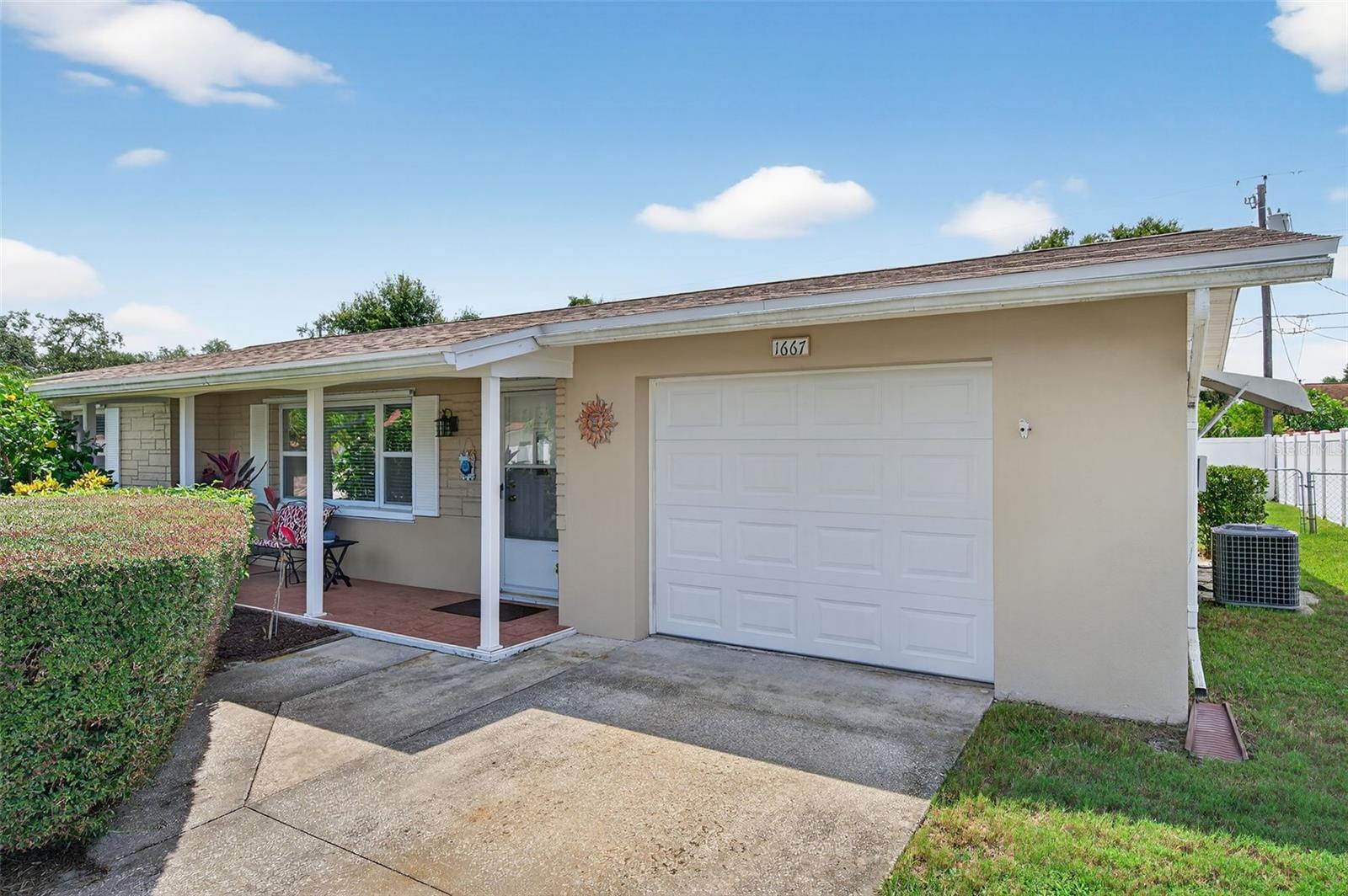 Welcome to the quiet low-key neighborhood located in the unincorporated Woodbridge neighborhood in Clearwater right next to Eagle Lake Park! This home has been meticulously maintained by the same owners for almost 20 years and offers two bedrooms, two bathrooms with a 1 car garage. Both bedrooms are graced with beautiful Brazilian Cherry solid wood floors, spacious built in closets, ceiling fans, and crown molding. The kitchen and Florida rooms are perfectly situated and allow abundant sunlight in the home. The main bathroom is vintage pristine! The yard is like a park and sits on 7,000 sq ft and completely fenced with its own well and six zone sprinkler system for irrigation. Relax in the spa with waterfall and lighting on a Flagstone paver patio added in 2021. Enjoy the KOI pond with fish and fountain, Wally Wat storage shed 2019, and the corner back yard has a beautiful mature Rain Tree with amazing flowers. The yard has plenty of room for a swimming pool and the side yard has a gate with room for a recreational vehicle or a small boat. You also have a new electrical panel with 200 amps in 2025, water softener, new shingle roof in 2023, Rheam Marathon rust proof water heater 2022, GE Profile washer and dryer 2025, 2 1/2 ton 13 seer air conditioner meticulously maintained consistently every six to 12 months, 1 car garage with air conditioning and side exit, Ring doorbell with two exterior cameras, and new windows in most of the home. You are within walking distance of Eagle Lake Park and Publix and close to 3 airports, gulf beaches, great dining and shopping, Saint Petersburg, Clearwater, and Tampa. Don't miss this great home that's just waiting for you to add your additional touches.
