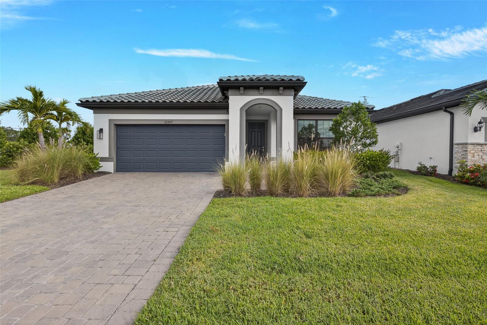 Like NEW home in Magnolia Ranch, a gated, boutique community where comfort meets style in this beautifully crafted 4-bedroom, 2-bathroom home built in 2022. Boasting 1,850 square feet of thoughtfully designed living space, this Highgate floor plan offers modern finishes and functional elegance throughout. The heart of the home is the chef’s kitchen—complete with a spacious island, gleaming quartz countertops, a stunning modern backsplash, and sleek tile flooring that flows through the main living areas. The open-concept design leads to an extended covered lanai, perfect for relaxing or entertaining, with a private backyard offering tranquil seclusion. Enjoy lake views from the front yard, a professionally landscaped yard with a paver driveway, and a tile roof that adds curb appeal and long-term durability. Additional features include a 2-car garage, hurricane shutters for peace of mind, and maintenance-free lawn care so you can spend more time enjoying life. Sidewalk-lined streets and a serene atmosphere make Magnolia Ranch a hidden gem. Low HOA and NO CDD fees here. Come experience the lifestyle you deserve in this move-in ready home!