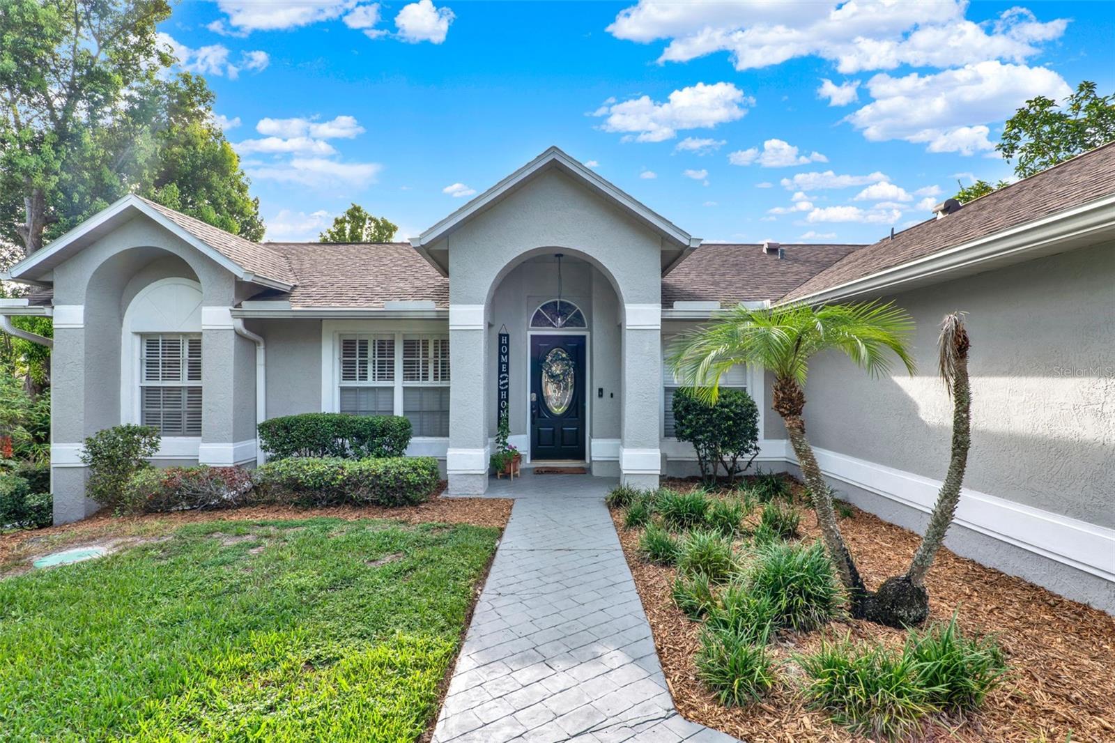 Discover this immaculate three-bedroom, two-bath home in sought-after Hills of Lake Mary community. This meticulously maintained residence has been thoughtfully updated throughout, offering modern comfort and timeless appeal in one of the area's desirable neighborhoods. The spacious primary suite serves as a retreat, featuring a generously sized walk-in closet and an elegantly appointed bath complete with a luxurious glassed-in shower, relaxing standalone soaking tub, beautiful marble countertops, and dual sinks for added convenience. Both baths have been tastefully remodeled with stunning marble tops that add a touch of beauty to the home. The heart of the home showcases a large great room with soaring vaulted ceilings that create an impressive sense of space and openness, ensuring no area feels underutilized. The gourmet kitchen is a chef's dream, featuring gorgeous quartz countertops, top-of-the-line stainless steel Samsung appliances, and a functional breakfast bar that seamlessly flows into the expansive family room, making it ideal for everyday living and entertaining. The thoughtfully designed floor plan includes a step-down living room highlighted by an eye-catching subway-tiled fireplace, while large windows frame beautiful views of the private fenced backyard and sparkling pool. Throughout the home, elegant plantation shutters provide both privacy and light control while adding to the property's refined aesthetic. Additional features include a newer roof for peace of mind and superior protection. The home's prime location offers a balance of tranquil neighborhood living while providing quick access to Interstate 4 and major thoroughfares, plus proximity to excellent schools. This turnkey property represents an exceptional opportunity to own a beautifully updated home in one of Lake Mary's desired communities.