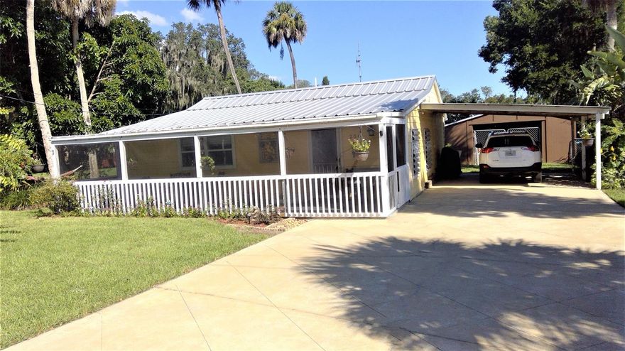 Wake up to find Home Sweet Home! Look at what just listed in a sleepy little riverside town in Florida. It's a mini farm complete with chicken coops and rabbit cages that have an auto watering system. Large avocado producing tree along with guava, mango, lemon, banana, and a fig tree. It's complete with the most adorable farmhouse. This 3 bedroom, 1 bath home has 837 square feet but it feels larger complimented by a large front porch and attached carport. The unfiltered well water is like fresh spring water. If you're looking for space to wander and love to fish, then this home is a must see! It's a short walk to the river which has fishing docks that extend out into the waters. It sits on two lots totaling .48 acres in the City of Oak Hill which is rich with old Florida history with small town charm. Centrally located between the shores of Cape Canaveral and New Smyrna Beach is an added bonus for your Florida lifestyle. Lots can be separated and were deeded separately when owners originally purchased this home.