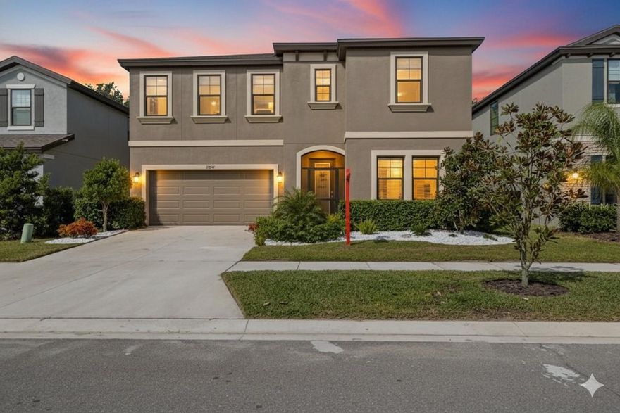 Welcome to Hawkstone! Discover exceptional living in the highly sought-after master-planned community of Hawkstone in Lithia, Florida. This elegant home showcases designer finishes throughout, including Sonoma Linen cabinetry, Calacatta Novello quartz countertops, and Ventura 7”x22” white wood tile floors. The Pelican floor plan offers a bright, open-concept layout designed for modern living and effortless entertaining. A welcoming foyer flows into the expansive grand room, a gourmet kitchen, and a charming café area overlooking the covered lanai. The main level also features a formal dining room, a secondary bedroom, and a full bath, providing both comfort and flexibility. Upstairs, a spacious bonus room connects three generously sized secondary bedrooms. The owner’s retreat, privately situated at the back of the home, includes a luxurious en-suite bath with a walk-in shower, soaking tub, and an oversized walk-in closet. A large laundry room on this level adds everyday convenience. Step outside to enjoy your professionally built extended patio, a $25,000 upgrade; perfect for morning coffee or evening gatherings. Additional enhancements include a whole home water softener, ceiling fans in the lanai and bedrooms, and custom front landscaping featuring rainforest white stone. Residents of Hawkstone enjoy resort-style amenities and an unbeatable location near top-rated Lithia schools, US-301, and I-75. Outdoor enthusiasts will love nearby attractions such as the 969-acre Triple Creek Nature Preserve, offering pet-friendly hiking trails just two miles south, and Triple Creek BMX, only one mile away. Experience refined living, natural beauty, and exceptional community amenities, all in one remarkable place. Come see this beautiful home today!