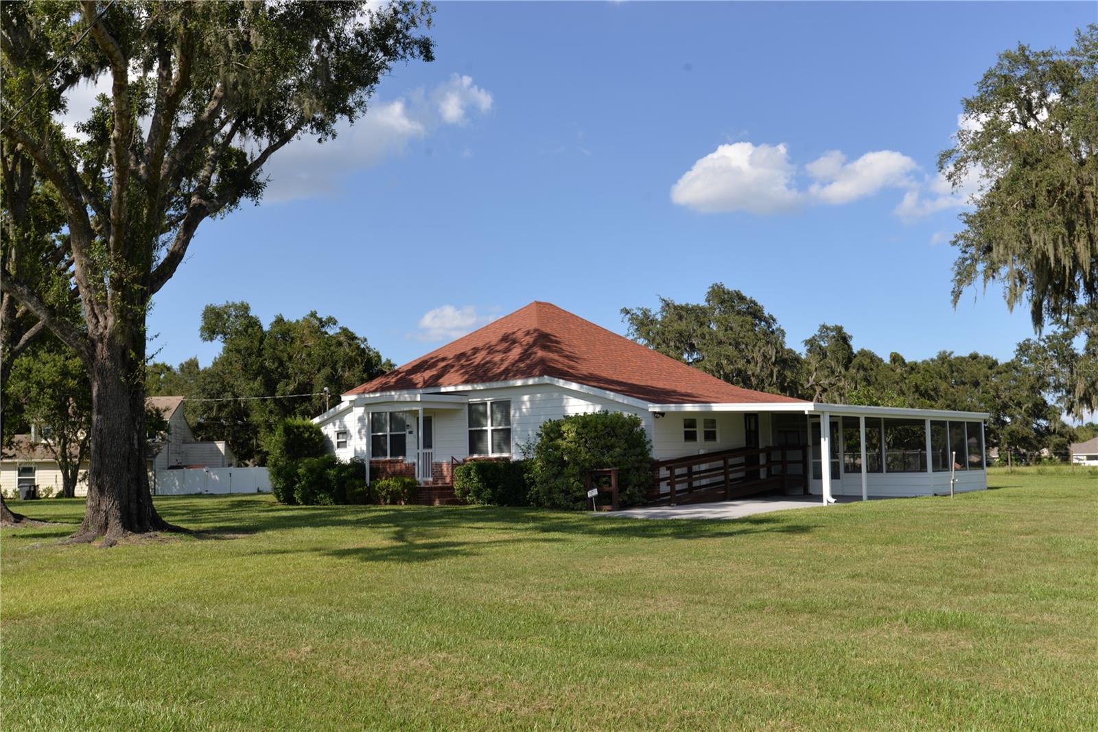 This is a beautiful 5.81 acres of wide open property! All grass, 10 beautiful Grandfather Oaks and the property is irrigated with a 4" deep well separating the rear acreage from the from yard. The acreage is cross fenced with horses and cattle allowed. Don't be fooled by the age of this home, it has been well maintained, A/C is 2012, Roof 2021, windows replaced in 2008, 3 bedrooms, an office, formal dining room and formal living room and an updated bath. In the rear of the home's back yard is a chain linked fenced area to let out household pets without worry! Almost 6 acres and perfect for your horses and cattle. This home has great opportunities to live in the country with some acreage yet be minutes away from Bartow, Winter Haven even Lakeland. Call today to see this beautiful property!