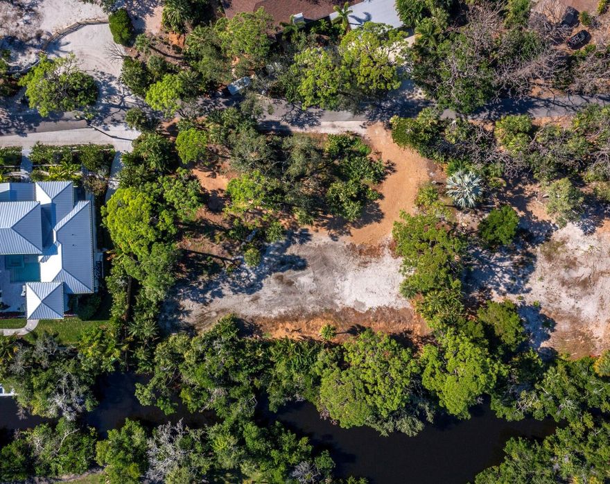 A rare opportunity to build a signature residence on one of the most private and picturesque parcels in the exclusive Sanderling Club on Siesta Key. This .73-acre homesite is tucked away on a quiet, canopy-lined lane, surrounded by mature tropical forest and majestic Live Oaks, offering unmatched tranquility and privacy. The entire eastern boundary of the property fronts the freshest waters of Heron Lagoon—directly across from the Sarasota Bay inlet—providing expansive, ever-changing views of this tidal sanctuary. Paddleboard, kayak, or simply relax as wildlife glides past your future backyard oasis. With all utilities in place and access to a private well for irrigation, this lot is cleared and ready for your dream estate. Just a short walk away, enjoy the powdery quartz sands of Siesta Key Beach and the Sanderling Club’s private Gulf-front beach, where members gather for sunset strolls and sightings of the elusive “green flash.” The community offers 24-hour attended gate security, a historic Paul Rudolph-designed clubhouse, tennis and pickleball courts, and a private marina with direct access to Sarasota Bay and the Gulf via the newly reopened Midnight Pass. The Sanderling Club is truly unique on the key, featuring an Old-Florida feel with meandering roads lined with mature trees, plus amenities that are simply unrivaled. Whether you envision a modern coastal retreat or a timeless island compound, this property offers the perfect canvas in one of Florida’s most prestigious beachfront communities with privacy, beach life and easy access to Siesta Key Village and Sarasota’s vibrant arts and dining scene.
