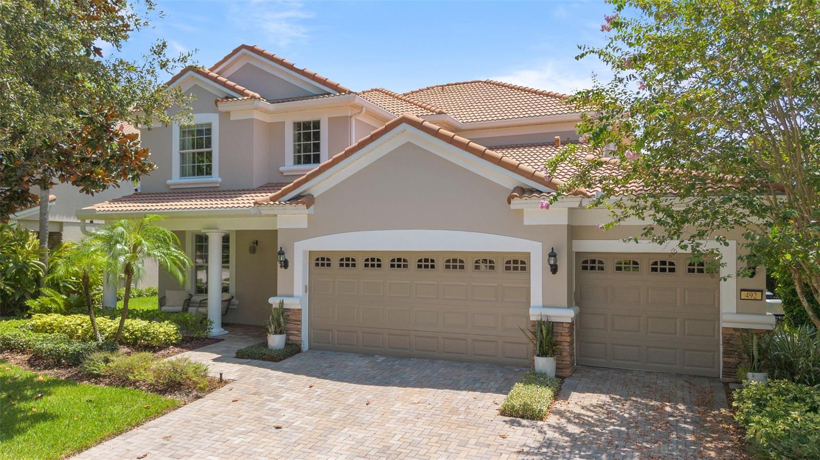 Located in the highly desirable Meadow Ridge, this stunning 4-bedroom, 3 full bath, 2 half-bath pool home is designed to impress from the moment you step inside. The interior showcases an open floor plan and space in abundance, with a chef’s dream kitchen with double ovens, an oversized island, and a generous breakfast bar, along with an elegant open dining room for additional living space. The flexible layout offers multiple options for relaxation, with a cozy family room off the kitchen and a spacious downstairs great room. Upstairs, gleaming hardwood floors lead you to the luxurious master suite with French doors and a grand feel. All bedrooms include custom closets and premium Hunter Douglas blackout shades. Additional highlights include an office that can double as a playroom or media room, plus a whole-house water filtration system. Two sets of sliding glass doors open to a private backyard paradise featuring a beautifully upgraded pool with in-water table and seating, an outdoor kitchen, lush landscaping, and an array of fruit trees. Meadow Ridge has its own club and resort style pool, and you’ll be within walking distance of A-rated Thornebrooke Elementary, zoned for Olympia High School, and minutes from 408, 429, the turnpike, Winter Garden Village, downtown Windermere, and Dr. Phillips’ Restaurant Row. Don’t miss the chance to make this exceptional home yours.