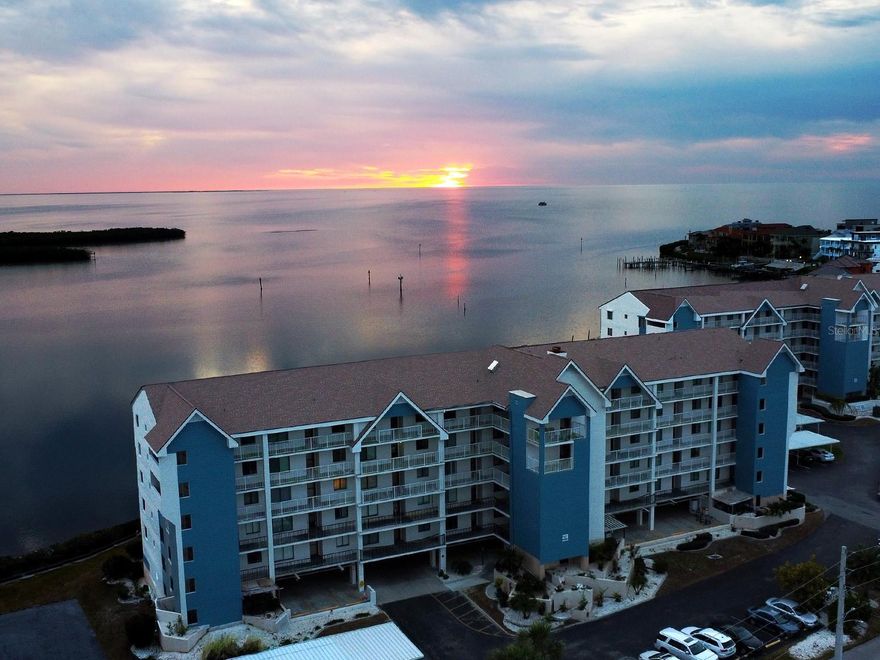 Experience the ultimate coastal lifestyle in this stunning condo featuring breathtaking open ocean views from your private sanctuary. This residence offers unmatched peace of mind with impact windows from the front and brand-new, remote-controlled hurricane shutters (2024) surrounding the entire property. The interior is move-in ready, supported by a reliable Rheem water heater installed in 2022, the rare convenience of assigned additional storage (#22) and a private parking space. Located in a premier community, you’ll enjoy access to luxury amenities including resort-style pools, a gym, tennis courts, a putting green, and a dedicated boat yard with slips available. You are perfectly positioned just minutes from local favorites like Whiskey Joe’s, Hooters, and Whiskey River for waterfront dining. Plus, the charm of historic downtown New Port Richey is only a short drive or boat cruise away, offering endless shopping and entertainment options.