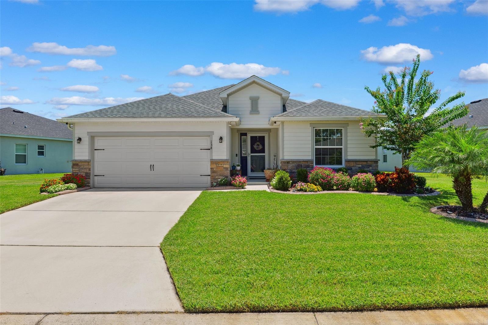 One or more photo(s) has been virtually staged. Why wait for new construction when you can move right into this practically brand-new 3-bedroom, 2-bath Highland Homes Serendipity model with charming curb appeal located in the desirable Bridgeport Lakes community in Mulberry, Florida. With over 2,025 sq ft of living space, this home has been meticulously maintained and thoughtfully upgraded, offering the perfect blend of comfort, function, and style. The layout features a wide foyer that opens to a spacious flex room—perfect as a home office, second living space, or easily converted into a fourth bedroom. Down the hall, you’ll find two guest bedrooms, a full bath, and a spacious open-concept kitchen and living area ideal for entertaining. The kitchen boasts a massive 11.5-foot quartz island with abundant seating and prep space, soft-close cabinetry, subway tile backsplash, an oversized walk-in pantry, and stainless steel Samsung appliances. The formal dining area offers plenty of room to host, while the living room features an oversized ceiling fan and access to the screened-in lanai, perfect for enjoying Florida evenings. The owner’s suite features tray ceilings, dual walk-in closets (one with built-ins), and a beautifully tiled walk-in shower with glass doors. Additional upgrades include luxury vinyl in the main living areas, blinds throughout, ceiling fans in every bedroom, a fully fenced backyard, gutters, and a front screened door. The home is also equipped with a 30-amp interlock breaker for a generator, to keep you comfortable incase of emergency. HVAC features a UV light filtration and transferable 10 year warranty. Home includes wired pest control system with termite protection pods in the yard, as well as the home. Garage features include ample upper storage and wall shelving. The oversized, pie-shaped lot offers a generous yard with tons of curb appeal. Located in a quiet, well-maintained neighborhood with low HOA dues ($900/year), Bridgeport Lakes is a growing community close to lakes, parks, and convenient commuter access. This turnkey opportunity combines the benefits of newer construction without the wait or hassle—schedule your private showing today!