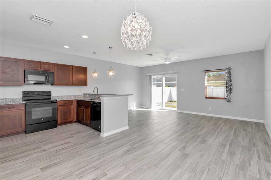 Completely Remodeled - Better than New as many upgrades made from original builder model. You will be the envy of the neighborhood. This 2-Story Cottage Design Home features Upgrades Galore including: Hurricane/Storm & Energy Efficient Windows and Slider. Newer AC With Air Purification System, Spray Foam Insulated Exterior Walls for added energy efficiency. Wood-Look Tile Floors throughout First Floor. Freshly Painted Interior. Premium Carpet in Bedrooms. Custom-Modern Tiled Shower in Master Bath with top line Fixtures. Beautifully updated kitchen boasting granite countertops, espresso wood cabinets, and a full suite of matching black appliances. The open layout connects seamlessly to the main living area — perfect for entertaining or everyday convenience. You will find elegant lighting fixtures, modern remote controlled ceiling fans and upgraded window treatments complimenting the open concept living spaces. When you are ready to step outside, you have a large fenced back-yard providing privacy and great space for family and friend gatherings. Room for a pool too! To finish off, you have new vinyl siding on upper exterior, paver driveway and a garage with painted floor. DO NOT PASS on this great opportunity to make this home your own. Excellent home for First Time Homeowners, Families or Snowbirds. Schedule your private tour today! One or More Photos Virtually Staged