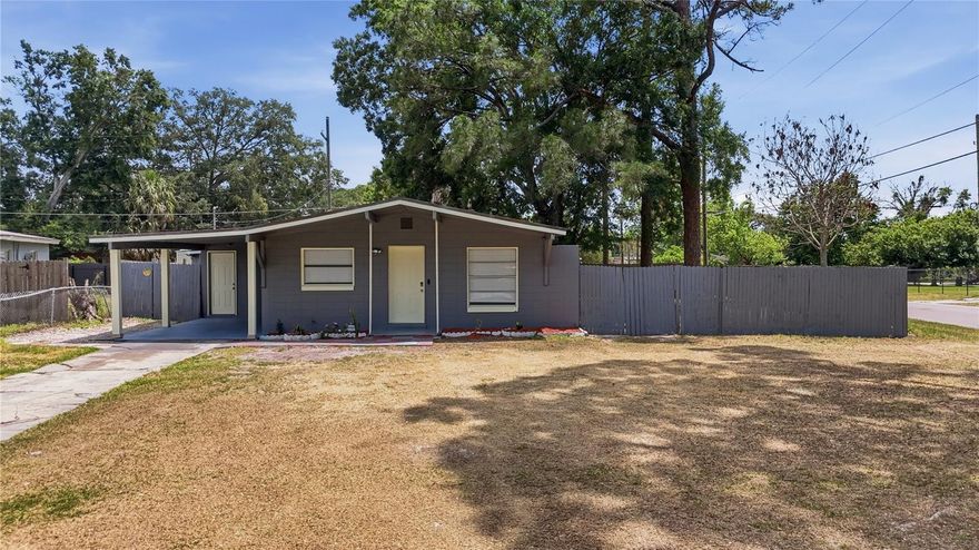 A Central Orlando address without the Central Orlando price tag. No HOA. No permission needed. Just freedom and one of the last true opportunities to plant roots in the heart of Orlando without compromising your budget or your lifestyle. While the rest of the market keeps climbing, 1401 Radleigh Pl delivers a 3-bedroom home on a large corner lot, minutes from downtown Orlando, Dr. Phillips, Restaurant Row, major employers, and everything Central Florida has to offer. The location alone tells the story but the home backs it up. Every inch has been thoughtfully updated: a fully renovated kitchen with rich espresso cabinetry, granite countertops, marble-look backsplash, and stainless steel appliances that make everyday living feel effortless. The bathroom is already done with floor-to-ceiling marble-look tile, clean vanity, nothing left on your to-do list. LVP flooring flows throughout the light-filled living and dining spaces, giving the home a cohesive, move-in ready feel from the moment you walk in. Three comfortable bedrooms. A dedicated laundry room. A covered carport. And then the backyard. A generous corner lot, the outdoor space is the real story here. Massive. Private. Canopied by mature oak trees delivering serious shade and serious peace. The Florida sunroom opens to it all your blank canvas for a home office, an entertainment space, or simply the place you disappear to on a Saturday afternoon with a cold drink and nowhere to be. Park the boat. Plant what you want. Paint whatever you want. No HOA means the only person who decides what this home looks like - is you. Corner lot. Central location. Move-in ready. This is what opportunity looks like in today's Orlando market. Contact us today to schedule your showing — this one won't last.