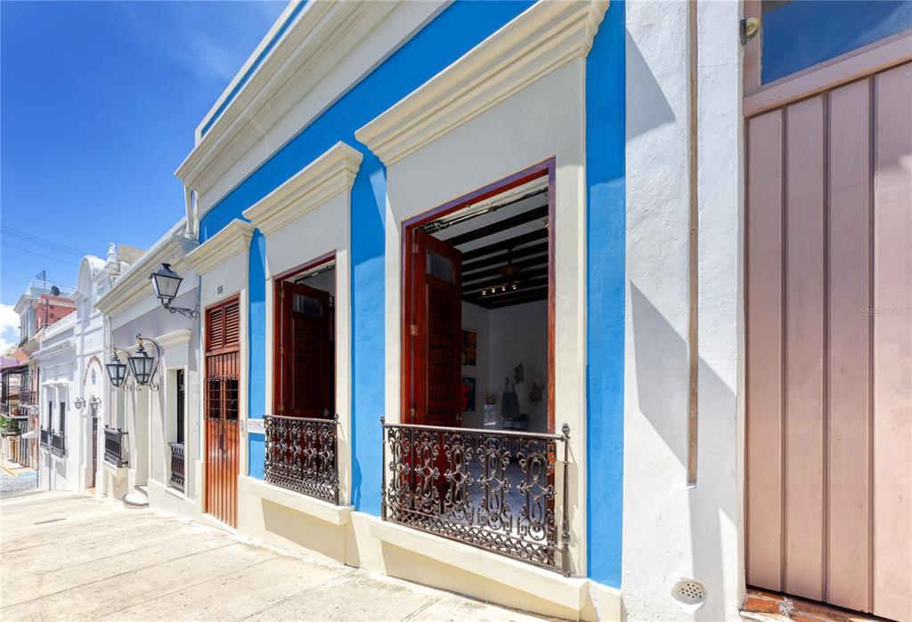 Spanish colonial treasure with significant historical value. Magnificently constructed in the 1800s, this exceptional two-level residence is a stunning representation of the unique charm and timeless romanticism Old San Juan is known for. Five bedrooms, five bathrooms and a powder room are spectacularly displayed throughout the impressive open floor plan, the majority of which is still adorned by its original and well-preserved marble flooring. The ample master suite includes a sizable walk-in closet and balcony. The spacious interior courtyard along with two adjacent bedrooms are highlighted by the calming water sounds of the cascading fountain and surrounding tropical flora. The home has been modernized throughout the years with contemporary features such as an elevator and entertainment area with rooftop Jacuzzi. Splendid city views and an abundance of natural light throughout all the spaces also serve to enhance this distinctive property. The rare opportunity of using the first floor as an apartment for short-term rentals and the second floor as a main residence is also conveniently available.
Old San Juan is the epicenter of Puerto Rican culture and is dotted with several UNESCO World Heritage Sites. It serves as one of the leading tourist destinations in the Caribbean and its celebrated buildings are renowned for their elegance and historic significance. The area is known for its numerous dining, shopping and nightlife options. Minutes away from Condado Beach and the Miramar Arts Districts. Walk along the cobblestone streets and experience the mesmerizing vibrancy of what we call El Viejo San Juan.