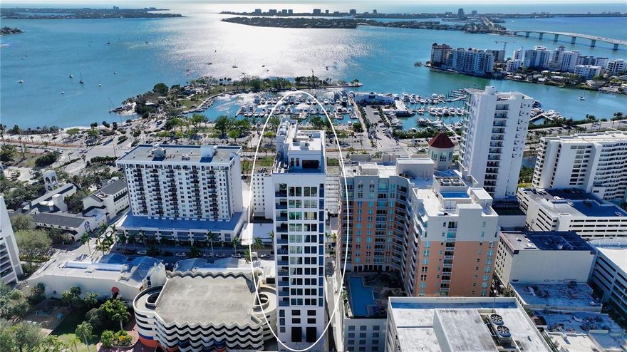 Experience the pinnacle of modern elegance in this brand-new, never-lived-in penthouse at The DeMarcay—located in the heart of downtown on Palm Avenue, just steps from Sarasota’s finest dining, art galleries, and boutiques.  Perched high on the 17th floor, this two-bedroom, two-bath residence captivates with panoramic views of Sarasota Bay, the Ringling Bridge, and the downtown skyline. Expansive windows and 14-foot ceilings fill the open-concept living space with natural light, creating a seamless connection between indoor luxury and breathtaking scenery.  The designer kitchen is a culinary showcase, featuring Italian cabinetry, quartz countertops, and top-of-the-line Miele appliances, including a gas cooktop. Every finish reflects thoughtful sophistication—from engineered hardwood and porcelain tile flooring to custom-built closets and a spacious walk-in pantry. The neutral color palette is pleasing for any decor.  Automated window treatments throughout, with blackout shades in the primary suite, give both convenience and comfort.  The primary suite features an expansive walk-in closet complete with custom cabinets.  Step onto your private terrace to enjoy the sunset, or retreat to the 18th-floor rooftop oasis—complete with a heated saltwater pool, outdoor kitchen, and multiple lounging areas overlooking the bay and city skyline. Additional amenities include a state-of-the-art fitness center and an elegant residents’ club room with dining, lounge, and catering kitchen. With 24/7 on-site staff, every detail of daily life is effortlessly managed. Whether you are looking for a year-round home or a seasonal escape, this pristine penthouse combines refined design, resort-style amenities, and an unmatched downtown Sarasota address. Come see it today!