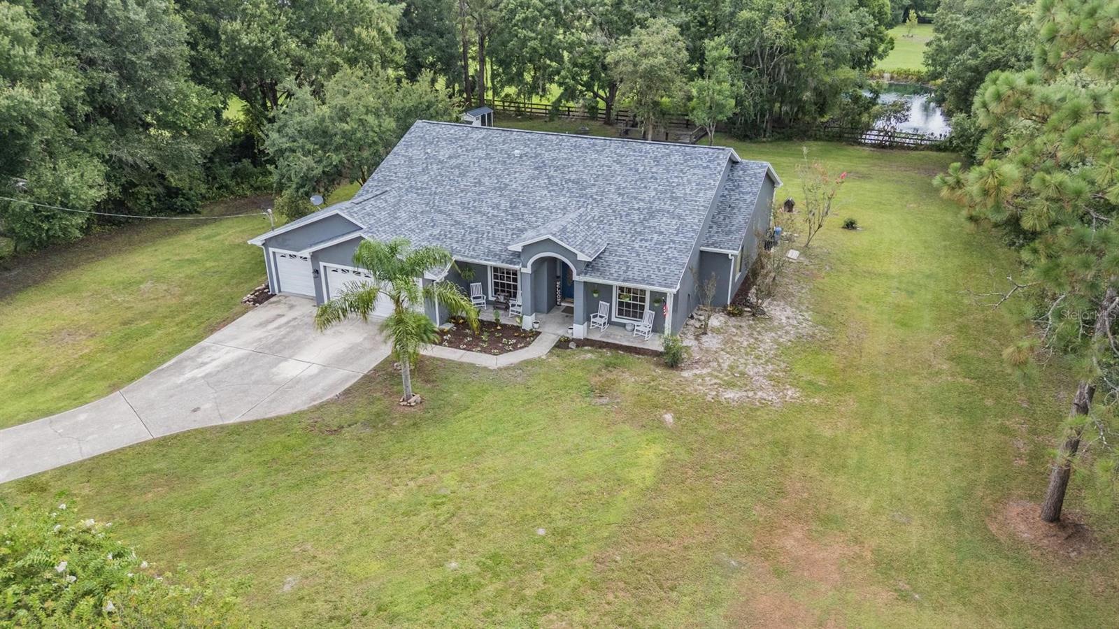 Welcome to 7305 Jones Road, Odessa, FL 33556 — a charming home offering 4 bedrooms, 2 bathrooms, and a spacious 3-car garage. Situated behind a gated farmhouse entry on a fully fenced lot, this property offers privacy, room to roam, and no HOA or CDD restrictions. Inside, the split floor plan provides both functionality and comfort, ideal for families or guests. Step outside to your personal backyard retreat featuring a beautiful in-ground pool with water features, a multi-level paved deck perfect for jumping, lounging, or entertaining. Whether you're hosting a cookout, enjoying a backyard bonfire, or soaking in the Florida sun, this outdoor space is built for year-round fun and relaxation. Located just minutes from The Shops at Wiregrass, Starkey Market, Upper Tampa Bay Trail, Suncoast Parkway, and top-rated schools, this property offers convenient access to both nature and modern amenities. Enjoy the freedom of country-style living without sacrificing location.This is a unique opportunity to own a versatile property in one of Odessa’s most desirable corridors—full of potential and ready for your vision.