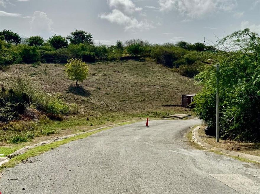 This property is lot 6 in the Posada del Coronel community on the beautiful Island of Culebra, Puerto Rico, one of the Spanish Virgin Islands. The Posada del Coronel complex is a quiet tranquil community that boasts wonderful views over the community, to Ensenada Honda Bay and to the Carribbean Sea.

The complex is a well thought out private community featuring excellent expansive building sites for your dream home on Culebra. The community is built in a “bowl” with gentle slopes along 3 sides of the bowl with the 4th side of the bowl being open towards Ensenada Honda Bay. Each property has views over the community and most have views out over Ensenada Honda Bay to the Caribbean Sea. The neighborhood is comprised of 41 residential lots between 1/2 to 3/4 acre in size. All the residential lots have gentle buildable slopes and access to utilities. There is also a 4 acre lot in the community that has been masterplanned and has past approval for a 30 room hotel. Another 3 1/4 acre lot in the community is master planned to be residential apartment housing. The community also has a 1 acre central park, pond, and recreation area.

The Posada del Coronel community boasts wide streets and underground utilities for aesthetics and storm security and allows short term rentals. In addition the neighborhood has protective covenants to protect the building parameters and quality of construction for new houses thus protecting all that purchase and build a dwelling in the community. The community has just started it's development as just a handful of the properties have houses constructed. This is a “ground floor” opportunity.

Lot 6 is 2700 square meters and sits on the right side of the bowl as one enters the community. From the community entrance gate the lot is the 5th lot on the right. The lot is ready for building with a gentle slope and has views toward Ensenada Honda Bay. The property has been cleared and the location gives it access to the Caribbean tradewinds. There is also a shipping container on the property for temporary storage.

The Island of Culebra itself is a small, idyllic island located about 17 miles east of the main island of Puerto Rico and 12 miles west of St. Thomas of the U.S. Virgin Islands. Known for its unspoiled natural beauty, Culebra is a haven for nature lovers, beach enthusiasts, and adventure seekers. Its tranquil atmosphere, crystal-clear waters, and pristine beaches make it one of the most sought-after destinations in the Caribbean. Whether you’re looking to relax on world-class beaches, explore underwater wonders, or immerse yourself in nature, Culebra provides an unforgettable Caribbean experience.

For beaches and watersports such as kayak rentals, paddleboard rentals, water taxi tours and jet ski tours, Posada del Coronel is centrally located within 5 miles of all the Culebra beaches.

In addition the Posada del Coronel community is just 2 miles from the town of Dewey where all the services and amenities in Culebra can be obtained.

For travel Posada del Coronel is just 1 mile from the Culebra airport and 2 miles from the Culebra ferry dock.

All in all Posada del Coronel is a centrally located affordable luxury community where the beauty and tranquility of Culebra can be experienced.