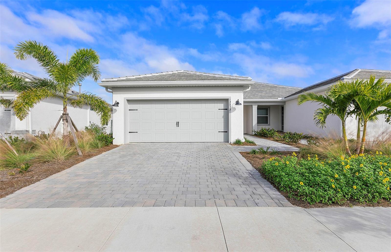 Step into luxury with this spacious Ellenwood Villa, nestled in an exclusive gated community that promises a maintenance-free lifestyle. In this top selling floorplan, elegance meets functionality with an array of high-end features designed for comfort and style. The heart of the home boasts abundant natural light, set against gleaming quartz countertops, designer backsplash, and pristine stainless-steel appliances, ensuring every culinary endeavor is a delight. Additional pendent lighting prep and recessed lighting throughout allow for well-lit entertaining and activities day or night. The spacious owner's suite with an upgraded tray ceiling detail is a sanctuary, complete with an en-suite bath with a linen closet, separate water closet, walk-in shower and an oversized walk-in closet to house all your essentials. Entertain or unwind in the covered lanai, and take in the Florida lifestyle with nightly sunset views. The 2-car garage with utility sink offers ample space for vehicles and storage alike. Beyond the exceptional features of the home, the community guarantees peace of mind with its secure gated entrance and the convenience of maintenance-free living. Get to know your new neighbors with private access to the community Pool and Covered Veranda, for residents only. Don't miss the opportunity to claim this gem as your own. Book a viewing today and experience upscale living at its finest!