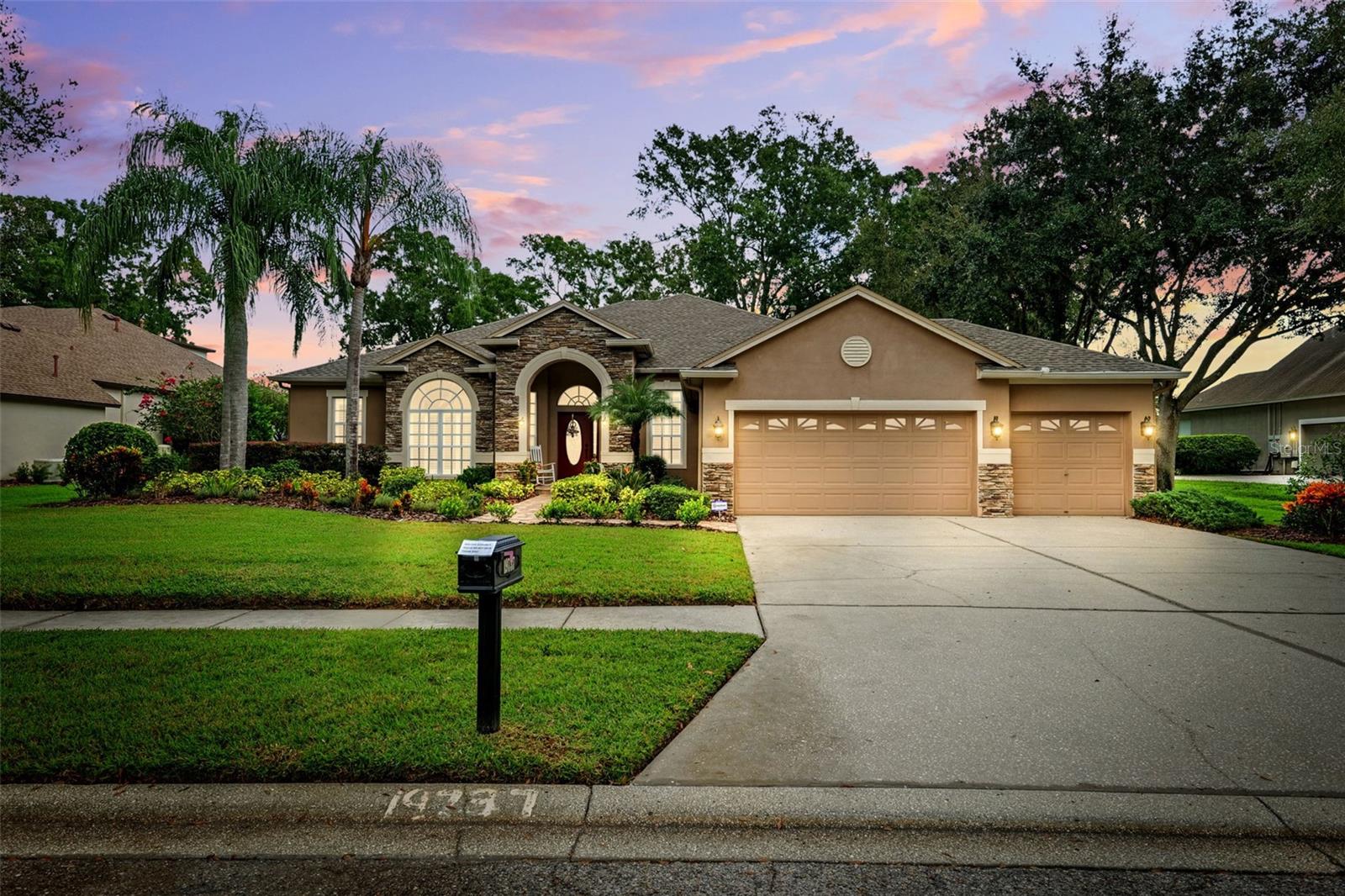 The Home You’ve Been Waiting For!   Welcome to this STUNNING David Weekley residence tucked within the Prestigious GATED Community of Wellington Manor. Nestled on a Quiet OAK-LINED Street, this 4-bedroom, 3-bath home sits on a Picturesque CONSERVATION lot, offering tranquil WATER VIEWS and timeless style.  Step inside to discover soaring ceilings, gleaming hardwood floors, and gracious formal living and dining spaces highlighted by crown molding and thoughtful architectural detail. The CHEF’S KITCHEN boasts GRANITE Countertops, 42-inch cabinetry, and opens seamlessly to the Spacious Family Room, where walls of glass frame peaceful pond and conservation views.  The luxurious primary suite features a Large WALK-IN Closet, Luxury Bath, and tranquil backyard views.  Three additional bedrooms, a private office/flex room, and two full baths provide elegant comfort and versatility for family and guests.
Outdoors, the AIR-CONDITIONED Extended Covered LANAI/SUNROOM invites you to unwind amid lush, mature landscaping on a HALF ACRE of privacy. This home offers the perfect blend of grace, comfort, and sophistication, with major updates including a NEW ROOF (2021), SEPTIC (2020), WELL SYSTEM (2020), updated A/C units, and GENERATOR.  Wellington Manor delivers the ultimate in luxury, location, and lifestyle—ideally positioned near US-41, SR-54 and I-75 for effortless access to shopping, dining, top-rated schools, and recreation, and easy commute to Tampa International Airport and the Gulf Coast’s pristine beaches.