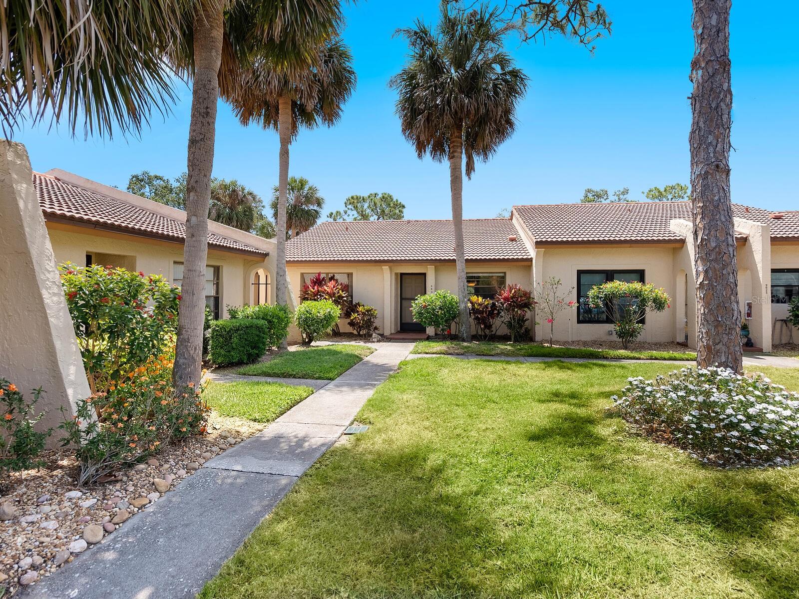 This charming two-bedroom, two-bath Briarfield villa is tucked within one of Sarasota’s sought-after communities, The Meadows. This 1,130-square-foot residence blends comfort and potential, offering long, tranquil golf course views with southern exposure that floods the interior with natural light all day long. Enter to find all-tile flooring throughout, vaulted ceilings and easy living. The extended screened patio is a standout feature, nearly doubling the outdoor living space and providing an ideal spot to unwind or entertain while taking in meticulously manicured fairways beyond. Ideal as a year-round home or seasonal retreat, this villa also includes a private garage with an automatic door, a classic tile roof, a light-filled kitchen overlooking landscaped garden space and spacious bedrooms with generous closets. In the quiet, tree-canopied enclave of Briarfield, this villa offers low HOA fees and turnkey convenience, making it an excellent opportunity for those seeking a relaxed, maintenance-free lifestyle with plenty of room to personalize. Residents of The Meadows enjoy a 1,650-acre planned community with resort-style amenities, including a modern wellness center, miles of recreational and biking trails, three golf courses, a country club, tennis and pickleball courts, a village center with activities, off-leash dog parks, and storage for RVs and boats, all just minutes from University Town Center, Nathan Benderson Park, and less than 15 minutes to downtown Sarasota and world-renowned beaches. This is your chance to live among the peaceful meadows and vibrant lifestyle The Meadows has to offer.
