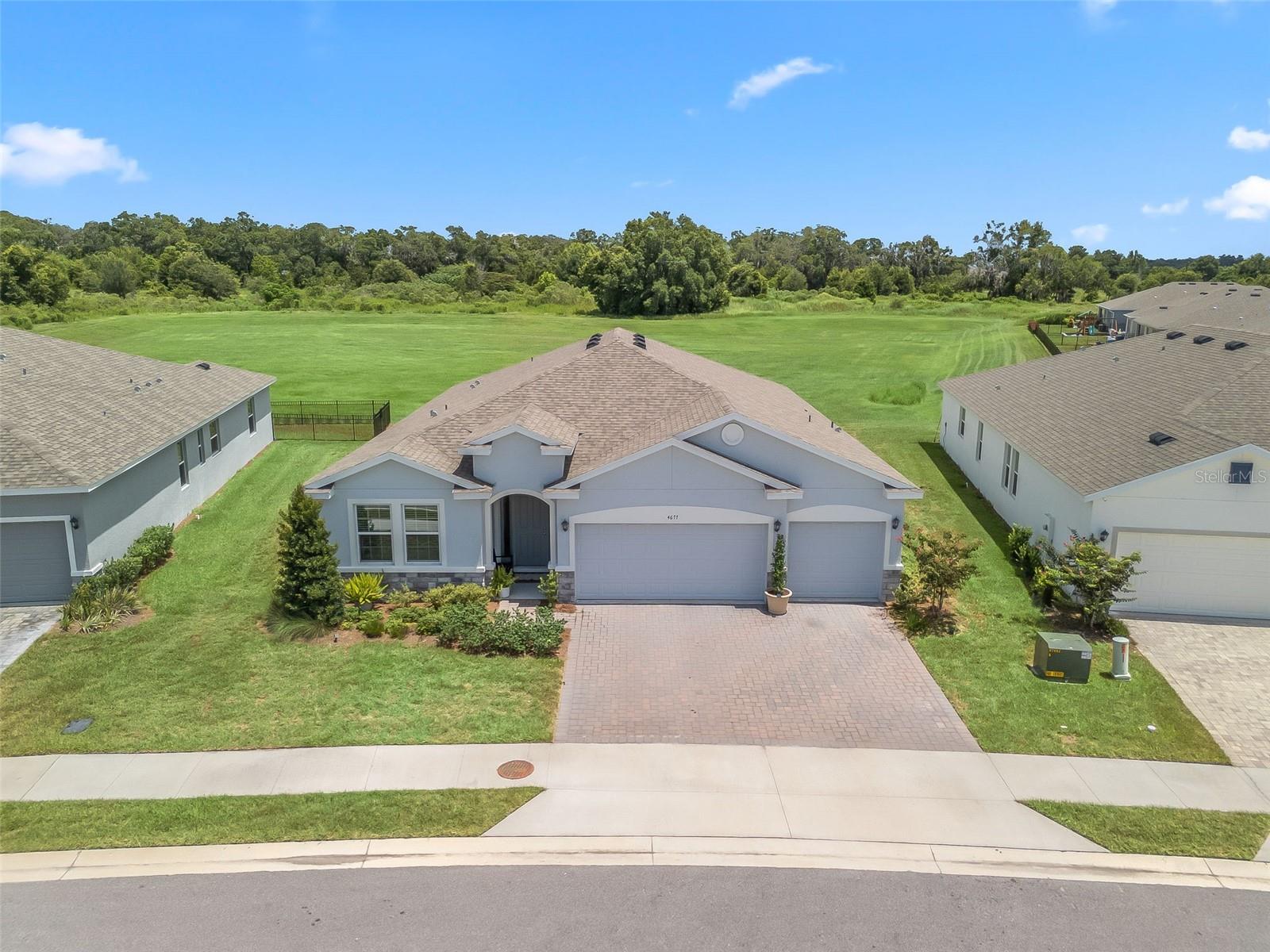Built in 2023 in the all ages area! This 4 bedroom, 3 full bathroom house with 3 car garage backs to permanent open space & is on an over-sized lot. Ocala's Finest Resort-Style Living- welcome to Ocala Preserve! Enjoy a private oasis with access to Walking/Hiking/Bike Trails, Tennis and Pickleball Courts, Resort Style Pool, On-Site Restaurant, Athletic Center, The Golf Club, Clubhouse, Day Spa and Dog Park. Relax on a kayak and watch the sunrise over our beautiful lake. Unwind at the end of your day with a glass of wine on the expansive Veranda, or enjoy a Chef inspired meal at Salt and Brick restaurant. This one-story, all concrete block constructed home has a truly open concept plan, featuring a great room with dining space that flows into the kitchen and dinette. Two bedrooms at the front of the home share a full bathroom, while the primary bedroom with an ensuite bath is located on the rear of the home for privacy, providing beautiful views of the backyard. The fourth bedroom next to the kitchen features its own ensuite bath and walk-in closet. This home includes granite counter tops in the kitchen & bathrooms & the kitchen has stainless appliances.
