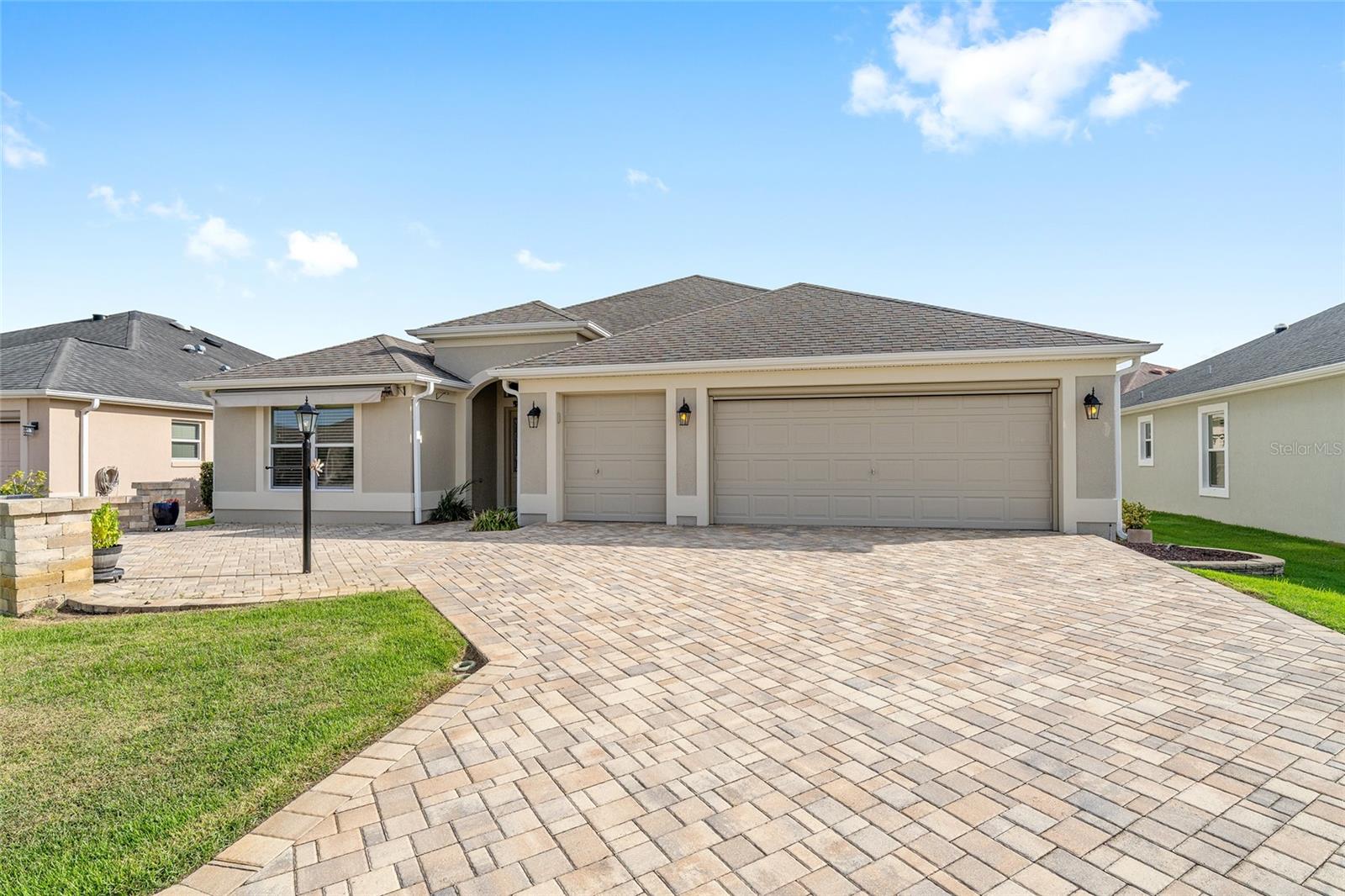 One or more photo(s) has been virtually staged. Welcome to 2942 Silk Tree! – Location, Location, Location - Highly Desirable Village of Sanibel! BOND PAID – Iris Model with Golf Cart Garage - A Great Home Starts with Road Appeal. A beautifully expanded paver driveway, walkway and a patio entertainment area with power awning! There is even a power screen on the main garage door. Step inside on the 24” neutral tile laid on the diagonal. The Iris features a front hall closet as you enter this open concept home. You have a dining area to the right and large main living area with a ceiling fan as you proceed. Kitchen features stainless Bosch dishwasher, microwave and newer GE refrigerator, solid surface countertops with breakfast bar, and cabinets with pullout shelves. The laundry is just off the kitchen and has storage cabinets, plus a built-in planning desk. There is also a dinette area for added eating space. The lanai floor has raised, patio doors removed, and large permanent windows added to give you a true spacious Florida room! The primary bedroom is large in an Iris with a coved ceiling ensuite bath featuring a Roman shower, dual sinks with separate vanities and a large linen closet. The oversized walk-in closet has custom organizer shelving including a jewelry drawer which will impress you! Back to front of the home, you’ll find two bedrooms with closets. One of the bedrooms is set up as a hobby room with added storage cabinets, desk space, laminate flooring, ceiling fan with a light kit and a Murphy bed. The other bedroom is carpeted and has a ceiling fan. The garage with plenty of space for your golf cart has a painted floor, Nova Triple Filter System plus a real bonus with MAGIC STAIRS that allow you to safely access your added storage above the garage.
Silk Tree Terrace is minutes to The Bonifay Championship 27 Hole Golf course plus its fabulous restaurant. In addition, you are a short cart ride to the Walmart Neighborhood Store, Colony Plaza with Publix with its many shops, restaurants, medical facilities, and gas station. You are also close to Lowes, Target, Home Depot, Starbucks and many other establishments with a ten-minute car ride if you choose. Drive up this street of quality Designer homes and you will want to make this your home!