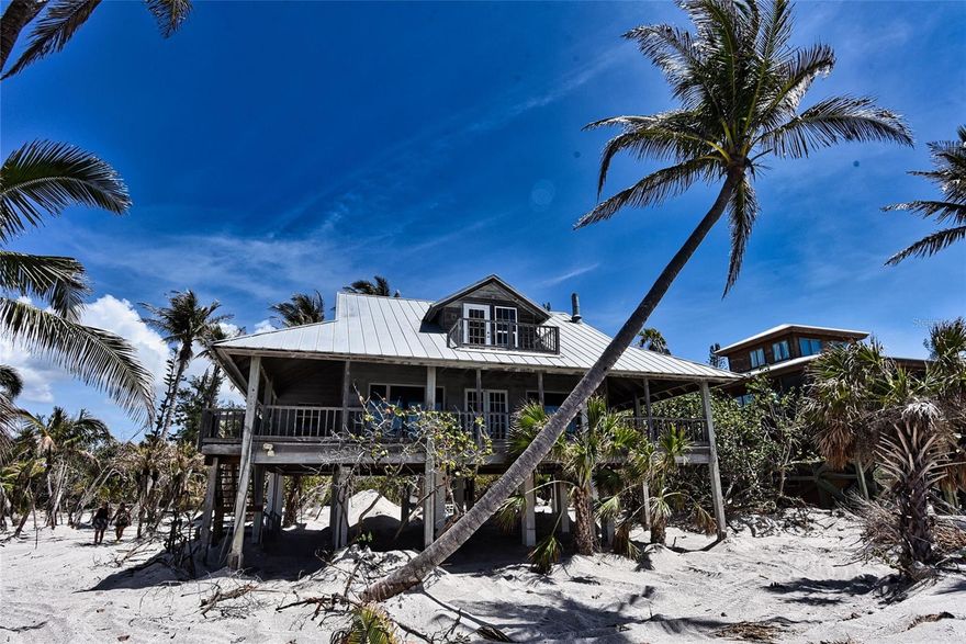 Private Beachfront Bungalow on Little Gasparilla Island – Your Island Paradise Awaits! Escape to your own slice of heaven with this stunning gulf-front 3 bedroom, 3 bathroom bungalow on a sprawling ½-acre lot on car-free Little Gasparilla Island. Accessible only by private boat or water taxi, this is your exclusive island retreat where tranquility meets adventure. Step inside to the warm, inviting interior featuring enticing wood plank walls, sleek tile floors, and a soaring open beam vaulted ceiling in the large central great room highlighted by knotty pine tounge and groove walls. A wood-burning fireplace sets the perfect ambiance, while expansive windows frame breathtaking beach and Gulf views. The full kitchen boasts custom wood cabinets, with full laundry room adding convenience. This home comes fully furnished—ready for you to move in and start living your island dream. Outside, a full wrap-around deck invites you to soak in incredible sunsets and listen to the soothing waves. Watch the Gulf sparkle from the upper deck or stroll the pristine beach collecting shells and shark’s teeth. Dive into endless activities—swimming, snorkeling, boating, kayaking, fishing, paddle boarding, and more—all from your private oasis. With no cars to disturb the peace, this bungalow offers unmatched serenity and natural beauty. Don’t miss your chance to own this furnished island getaway—schedule your private tour today and claim your piece of paradise!
